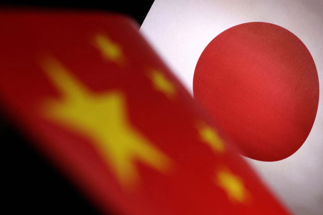 Printed Chinese and Japanese flags are seen in this illustration on July 21, 2022.