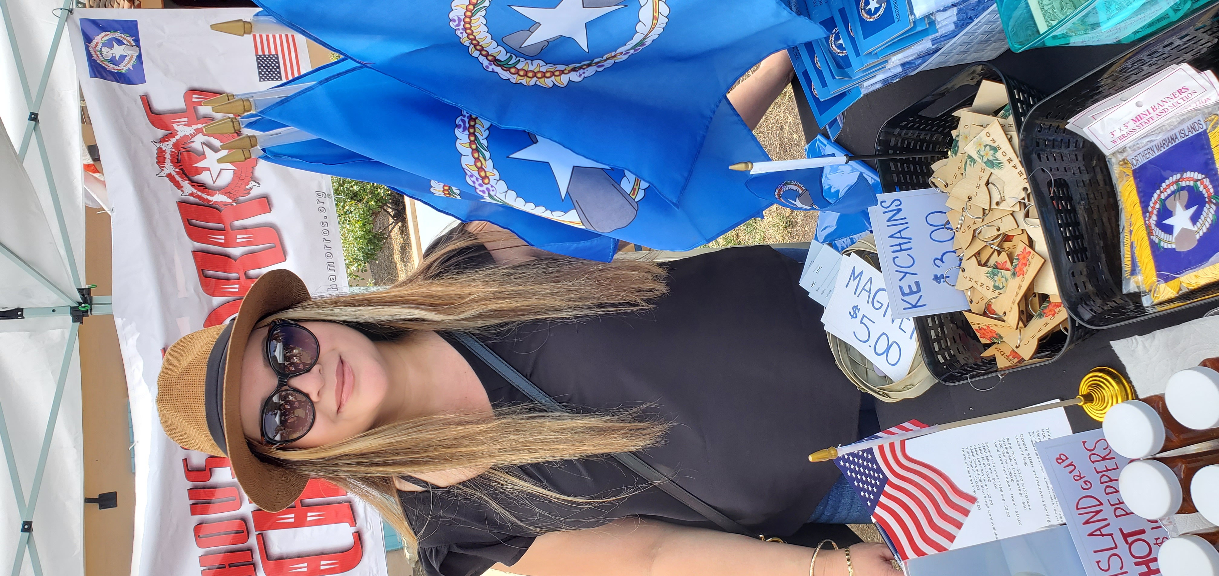 Hafa Adai Festival Volunteer Janice Santos helps sell local souvenirs to visitors.  Proceeds will go to help provide cultural educational activities at the House of Chamorros.