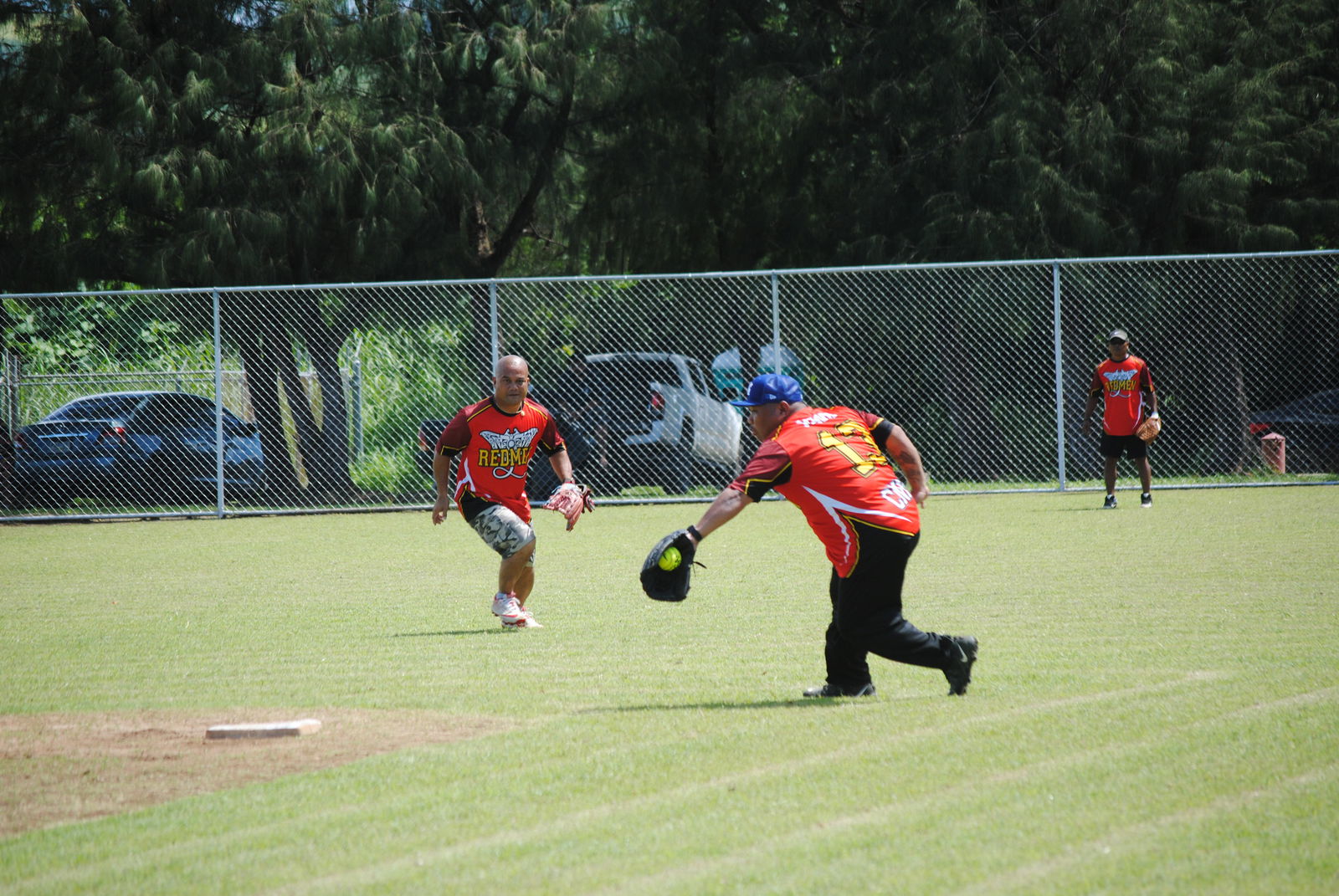 The Redmen's second baseman Greg Magofna secures the grounder for the out at first base during a 2022 Budweiser Belau Amateur Softball League game Sunday at the Dandan baseball field.