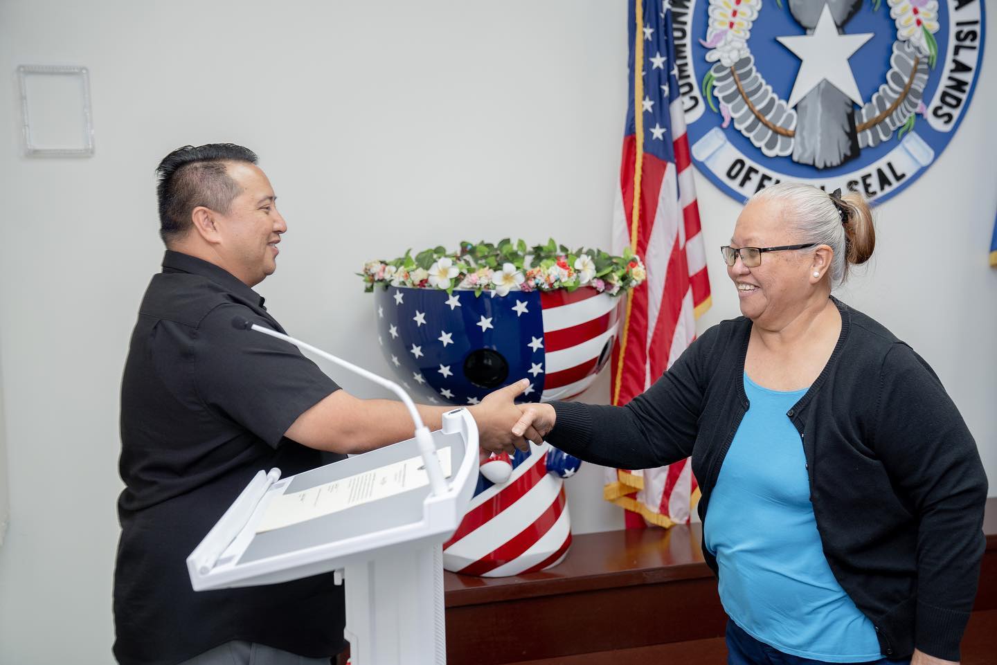 Elaine H. Orilla shakes hands with Gov. Ralph DLG Torres on Friday after being sworn in as the Northern Marianas College regent representing Rota.