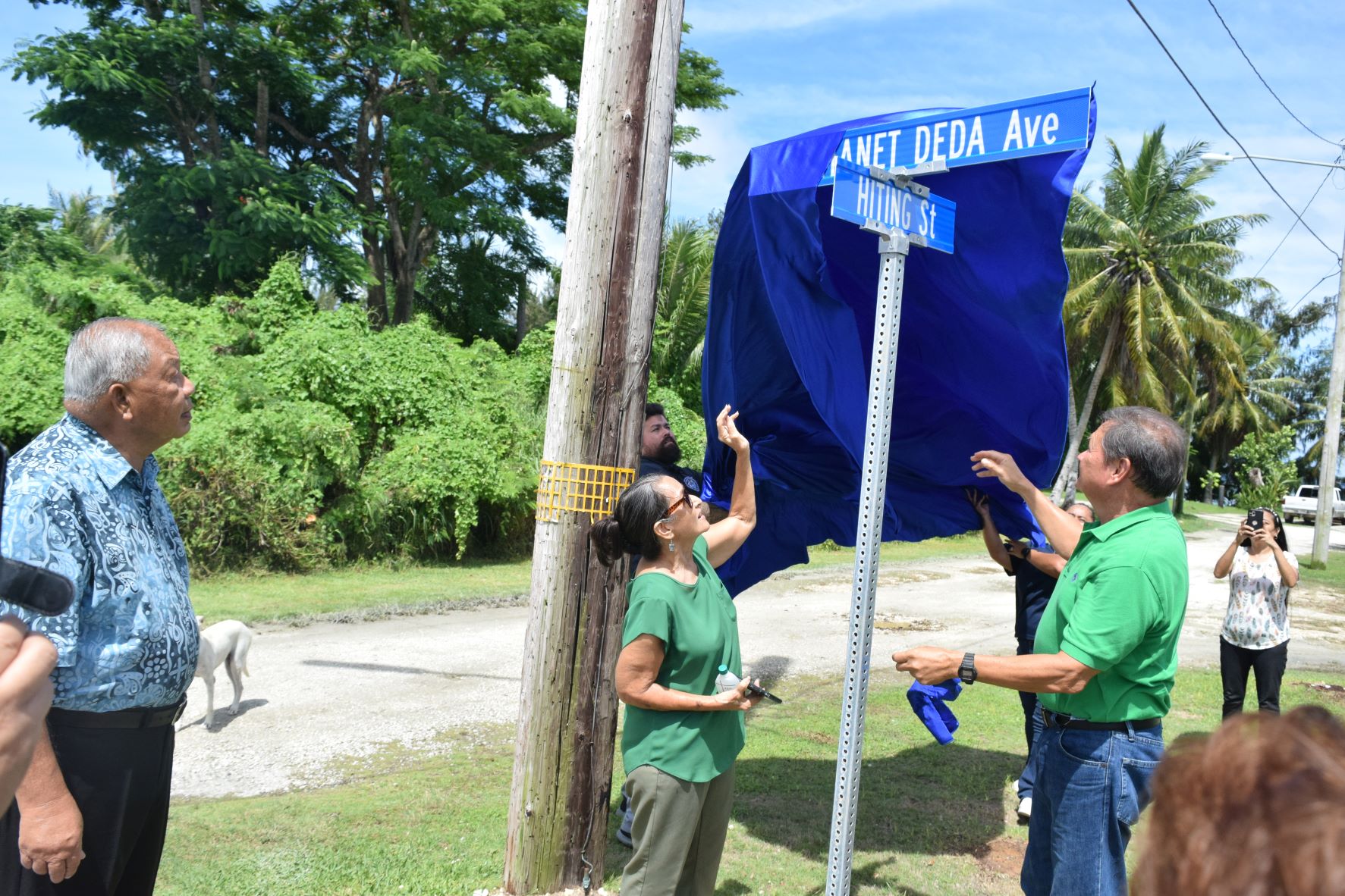 Saipan Mayor David M. Apatang, left, watches as Tun Manet Deda's children, Josephine and John, unveil the new street name in honor of their father.