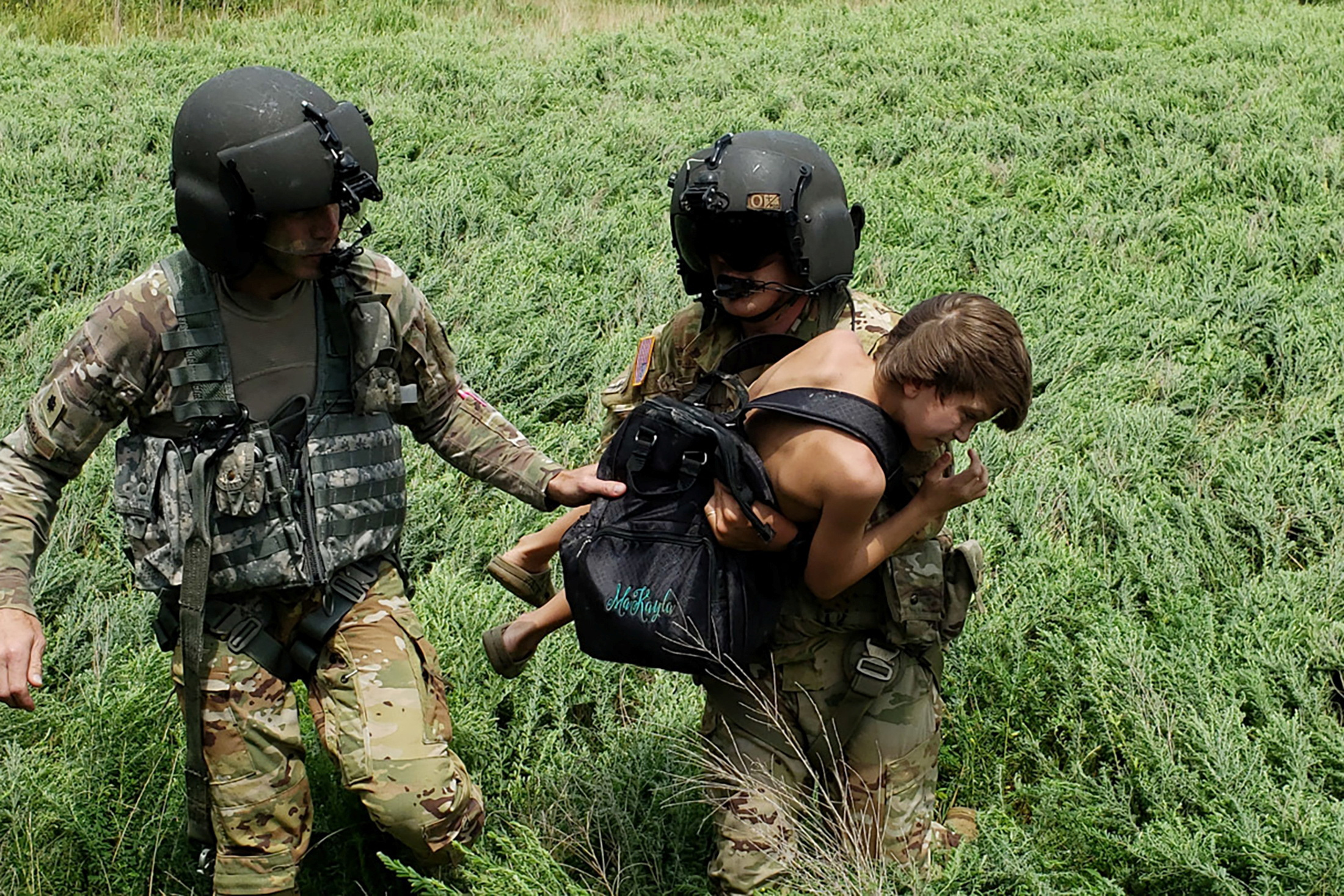 Kentucky National Guard helicopter crewmembers carry a victim of flooding during their deployment in response to a declared state of emergency in eastern Kentucky, July 27, 2022.
