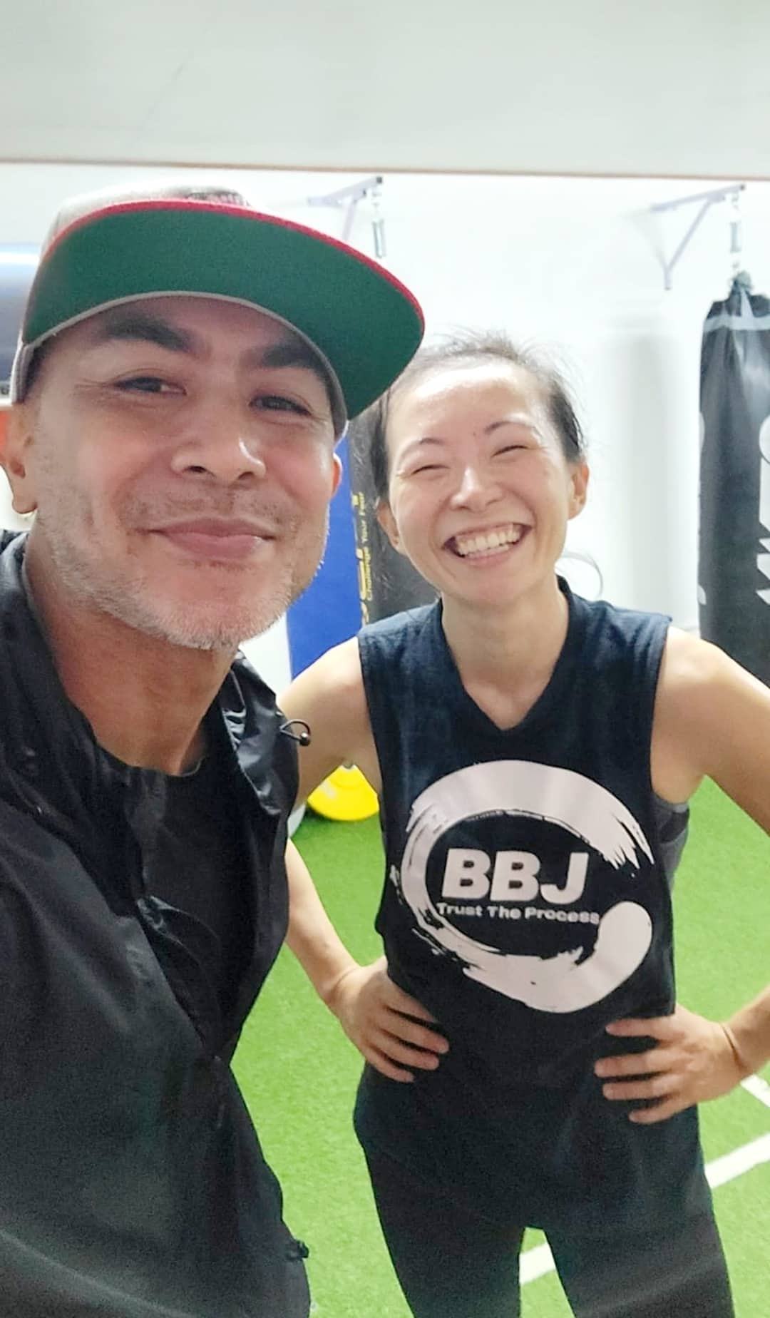Dr. Maria Hy smiles as she poses for a photo with personal trainer Jerry Diaz at BBJ Athletics Studio.