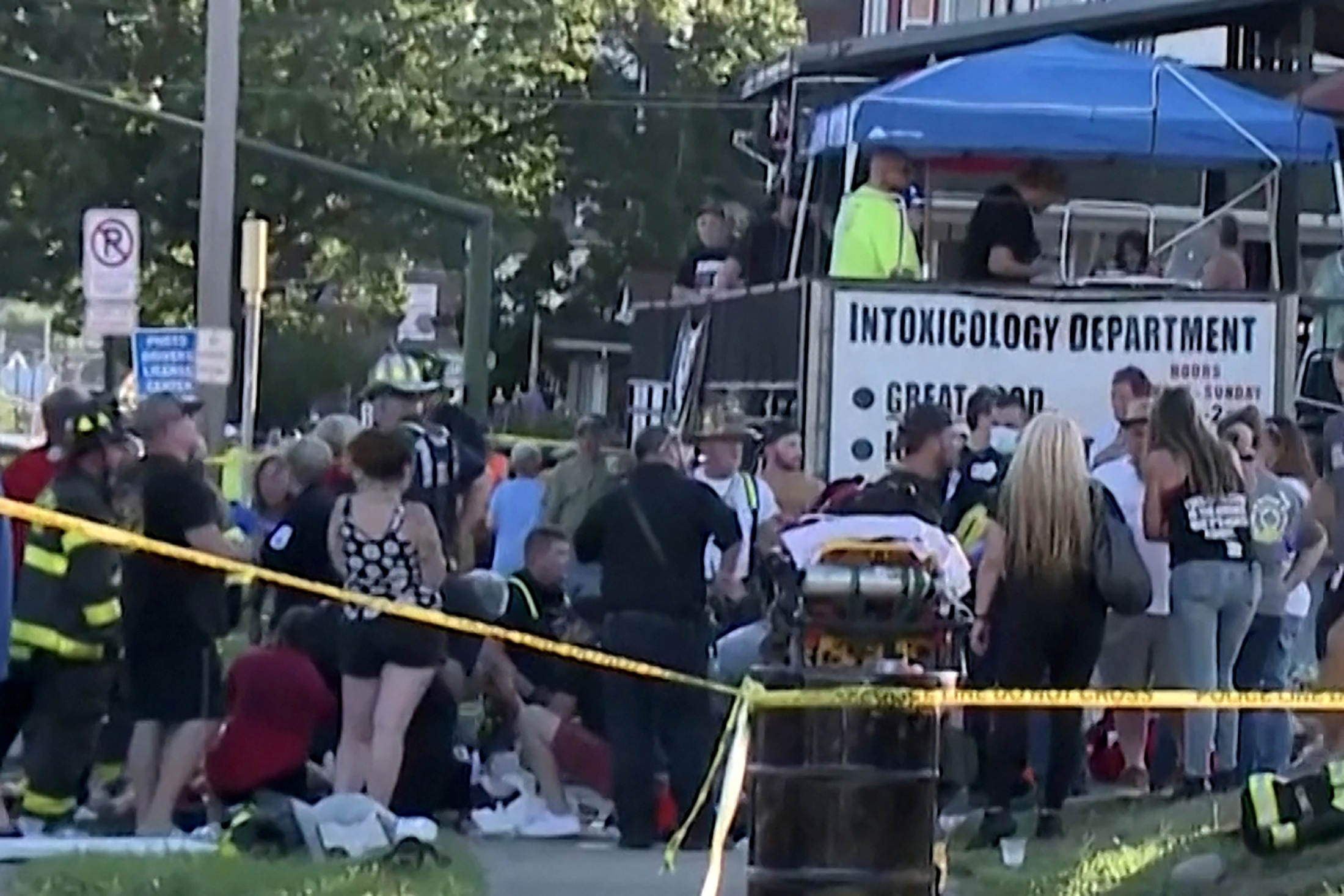 Emergency personnel attend the scene where a car was driven into a crowd during a benefit for families of the Nescopeck fire victims at the Intoxicology Department bar in Berwick, Pennsylvania, Aug. 13, 2022 in a still image from video.