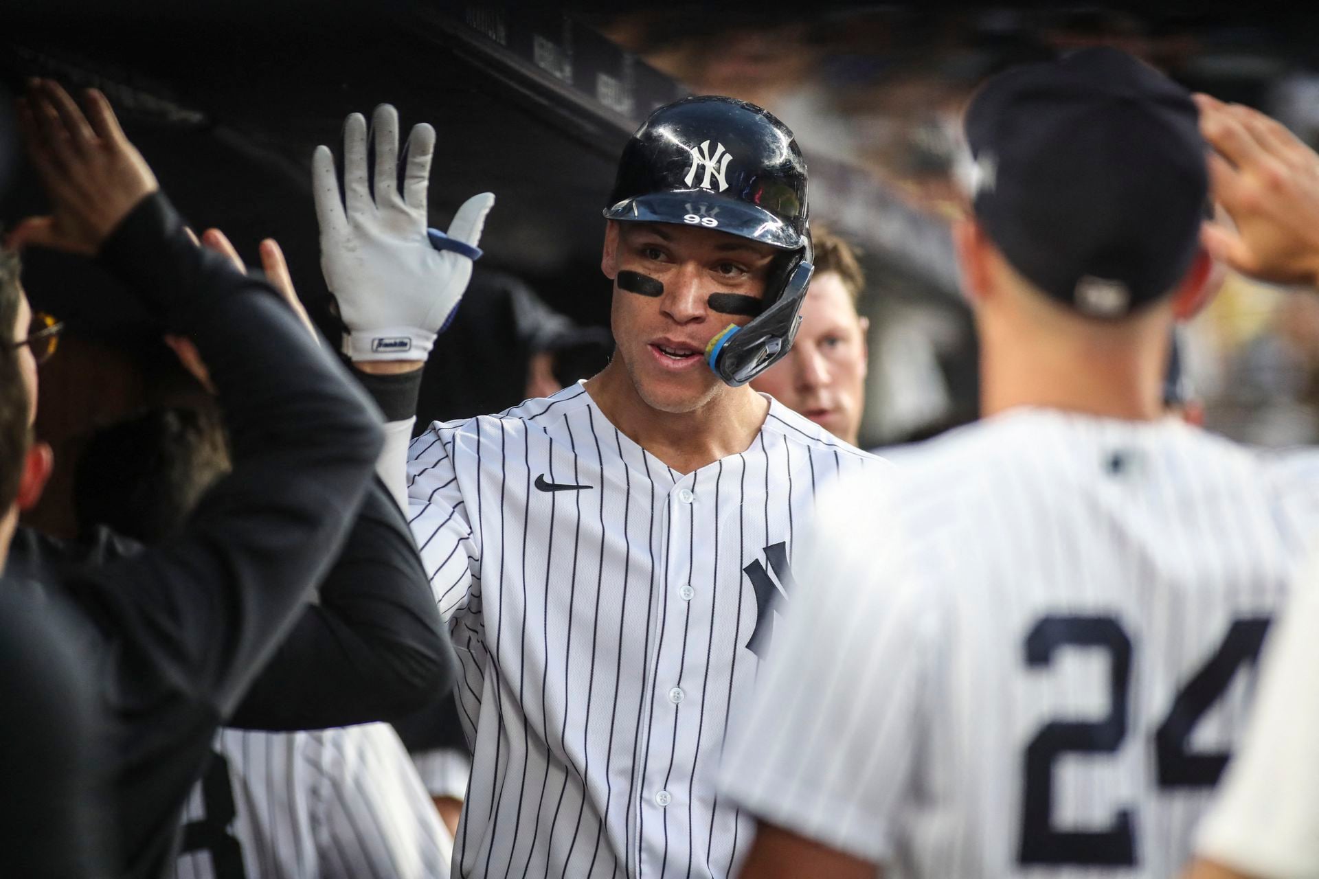 New York Yankees right fielder Aaron Judge (99) celebrates in the dugout after hitting a two run home run in the third inning against the Kansas City Royals at Yankee Stadium in the Bronx, New York, July 29, 2022.