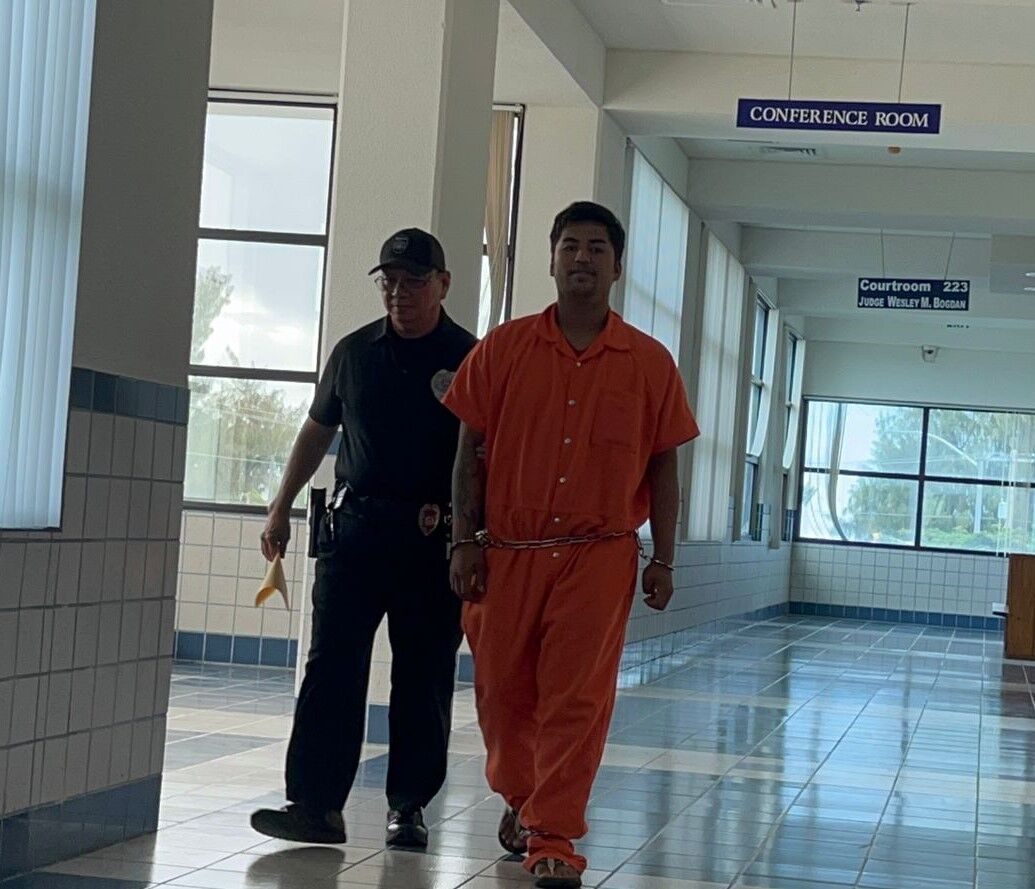 Kobe Abobo, 22, right, is escorted by Corrections Officer Candido Aldan after a bail hearing before Superior Court Associate Judge Wesley Bogdan on Monday morning.