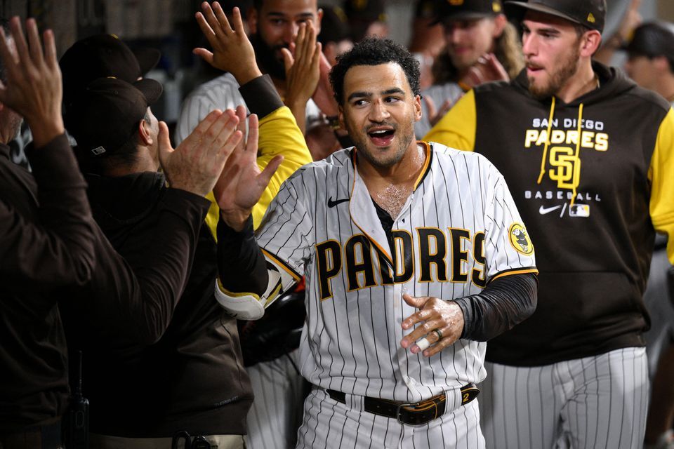 San Diego Padres center fielder Trent Grisham, left, celebrates his walk-off home run against the Colorado Rockies with teammates at Petco Park in San Diego, California, Aug. 2, 2022.