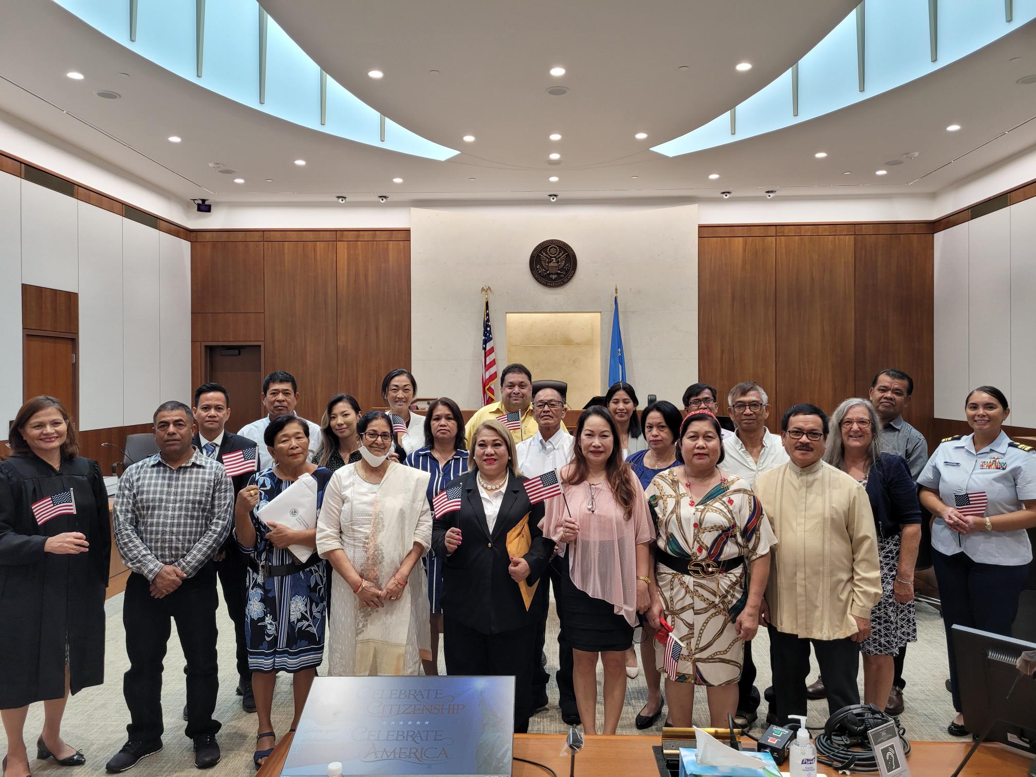 The new U.S. citizens who were sworn in Monday afternoon pose for a photo with Chief Judge Ramona V. Manglona of the District Court for the NMI, U.S. Coast Guard Lt. Cmdr. Christine Torres Igisomar and U.S. Citizenship and Immigrations Services Officer Patricia Phelan.