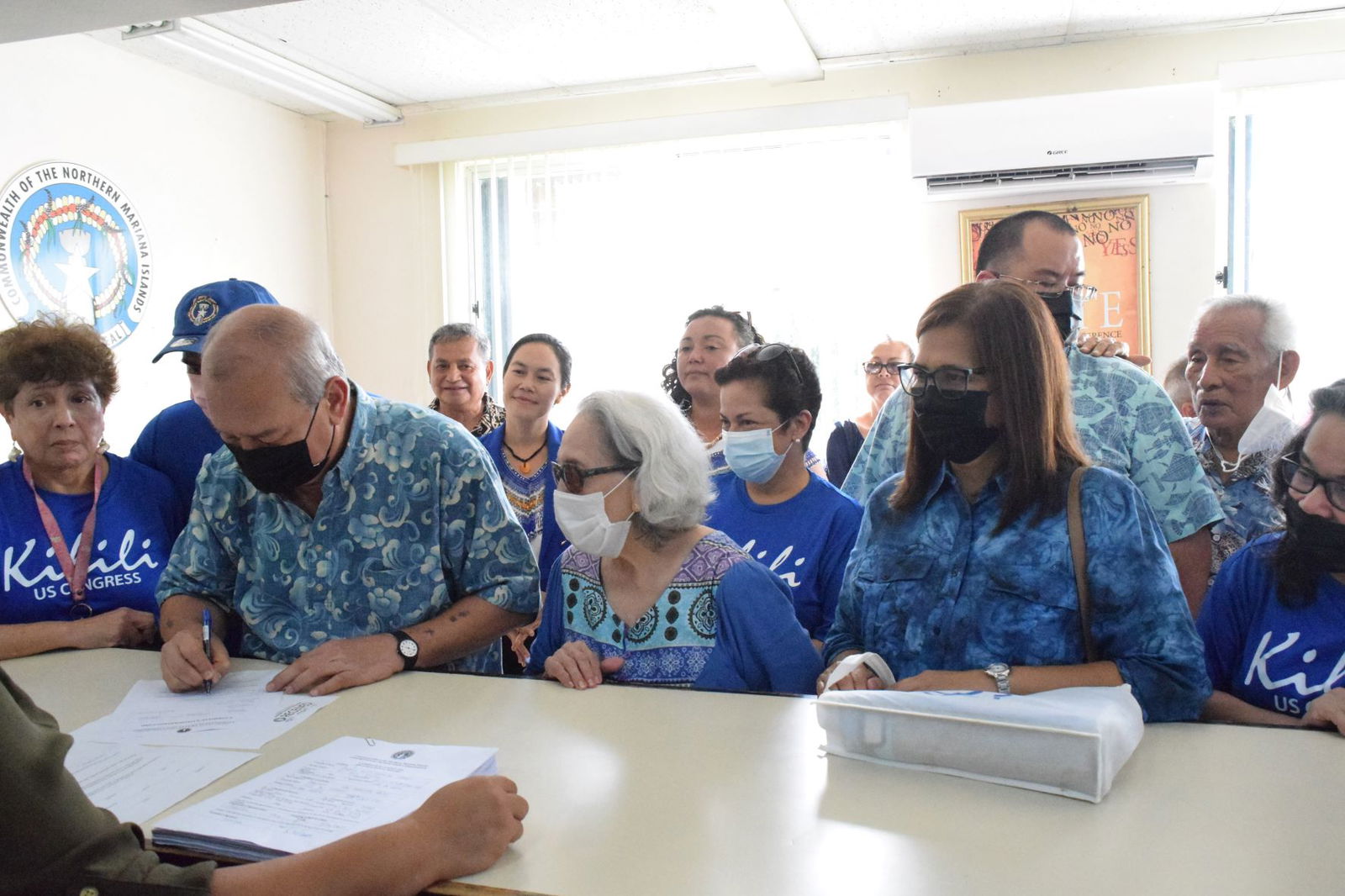 U.S. Congressman Gregorio Kilili Camacho Sablan files his candidacy at the Commonwealth Election Commission on Friday. With him are his wife, Andrea, second right, NMI Democratic Party gubernatorial candidate, Rep. Tina Sablan, four left back row, her running mate, Rep. Leila Fleming Staffler, center back row, mayoral candidate Rep. Richard Lizama, third left, back row, Speaker Edmund S. Villagomez,  second right,  the first CNMI governor, Carlos S. Camacho, family members and other supporters.