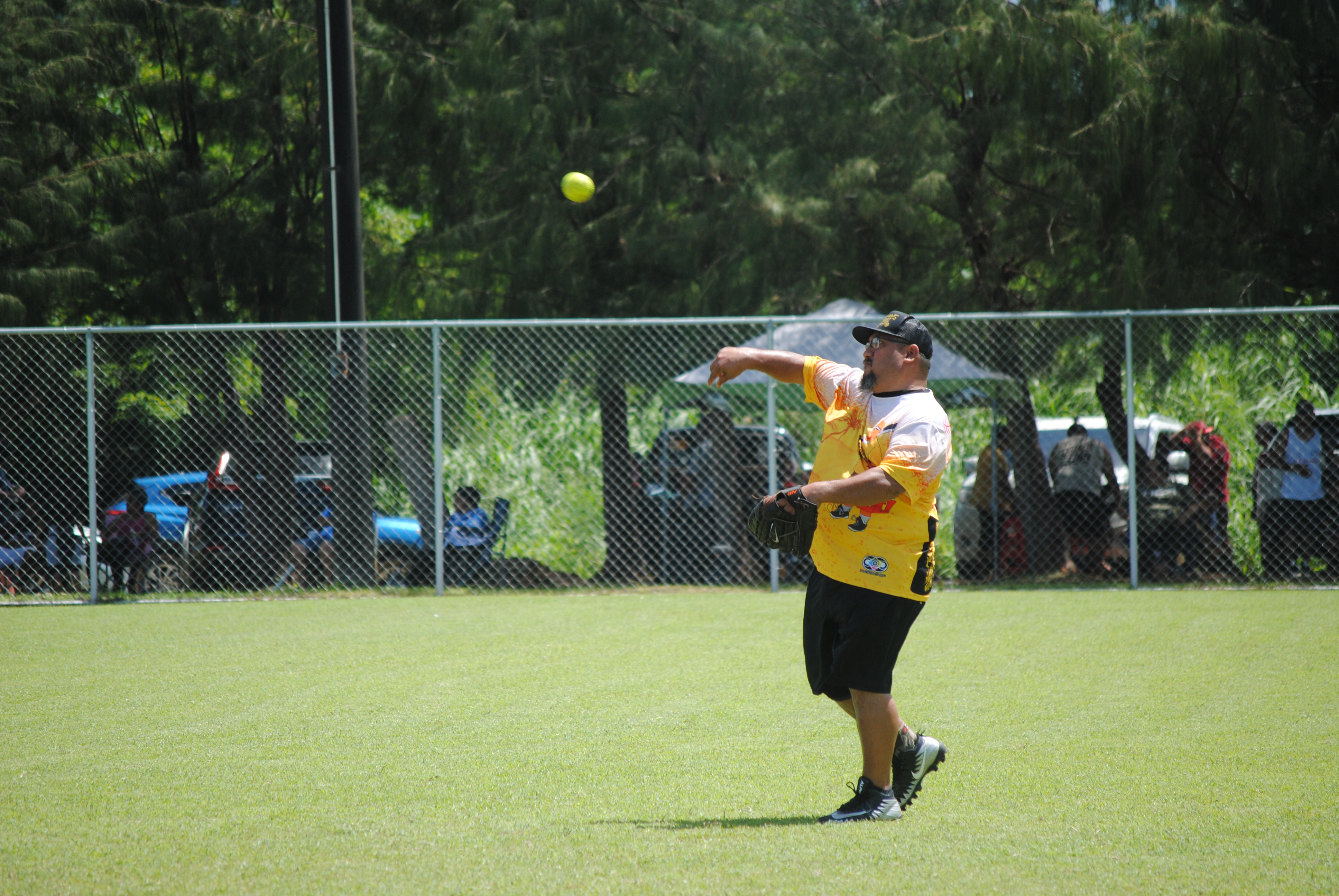 Hagu Lamun's Henry Lizama tosses the ball after a successful catch for the out during a  Budweiser Belau Amateur Softball League game at the Dandan baseball field.