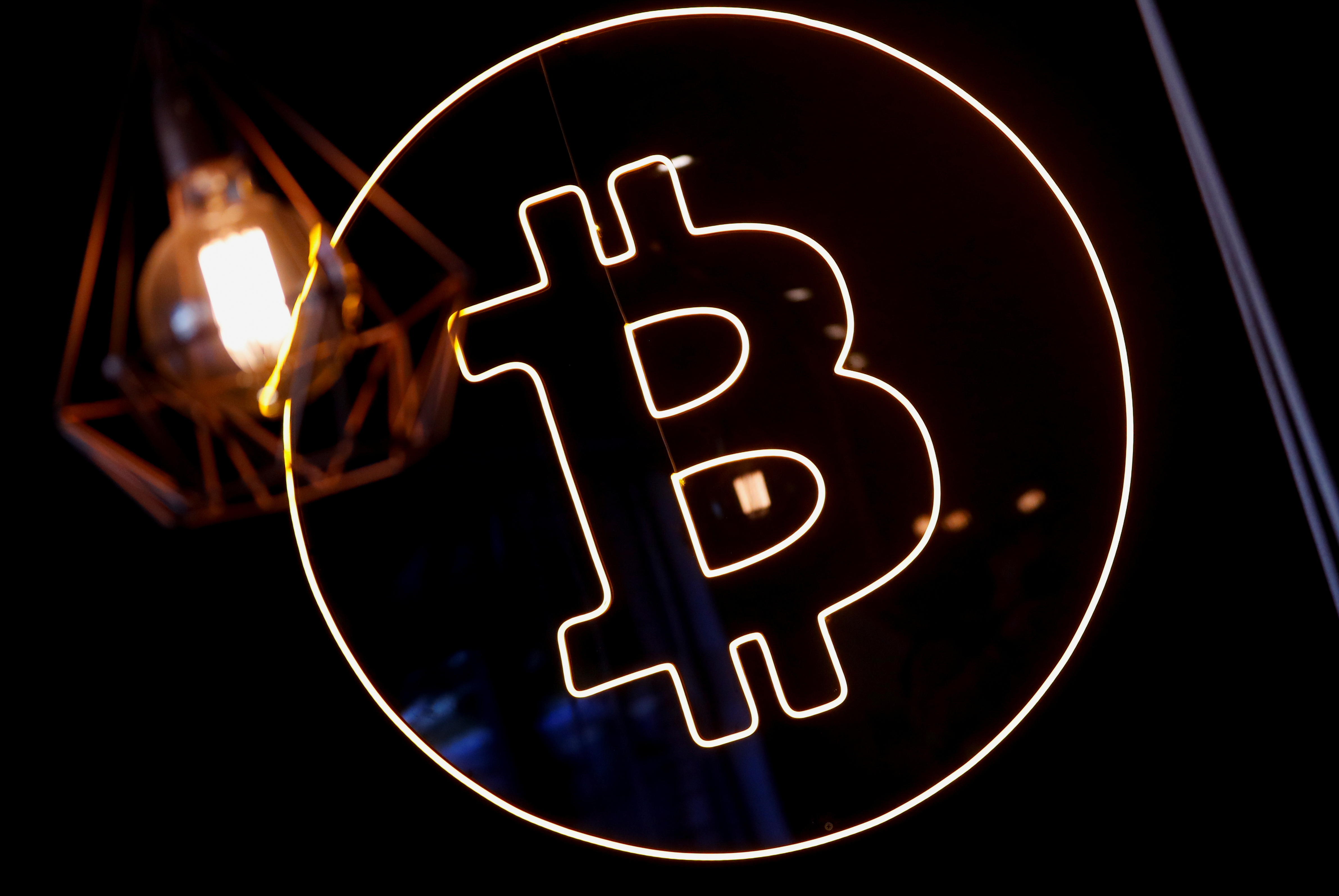 A neon logo of cryptocurrency Bitcoin is seen at the Crypstation cafe, in downtown Buenos Aires, Argentina, May 5, 2022.