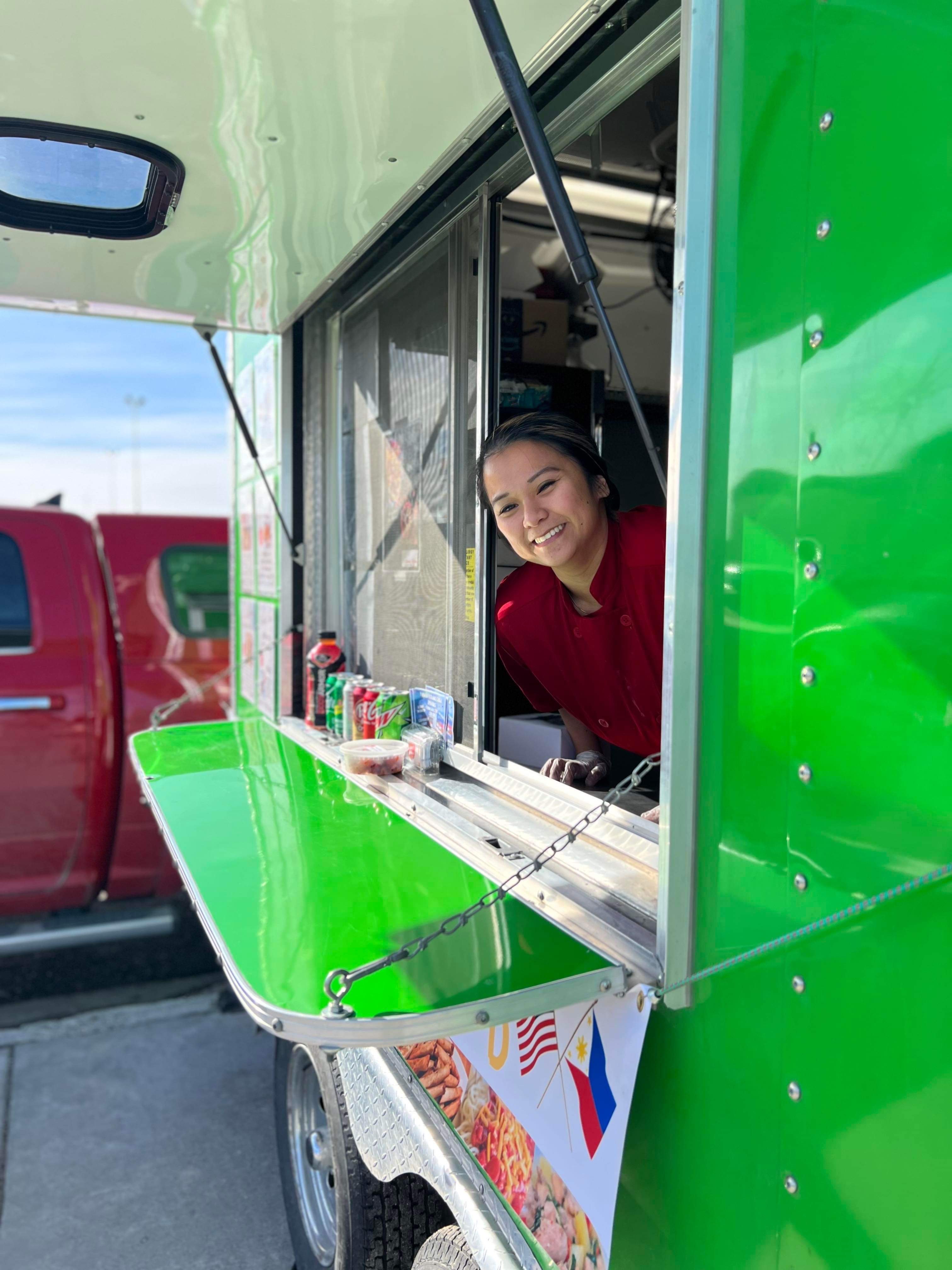 Aderwyn Jade Graybeal, co-founder of Nanay's Kitchen, poses for a photo inside of her food truck in Alaska.