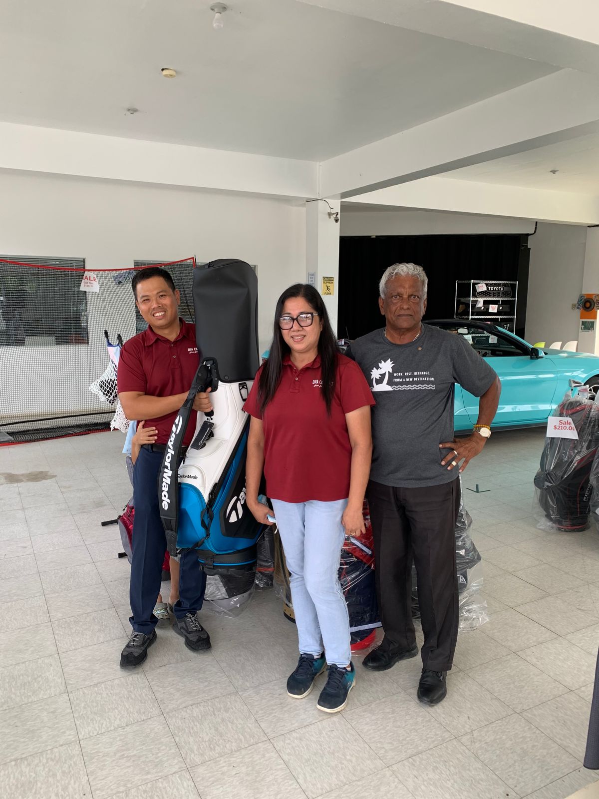 DPA Car Mart General Manager Pc Wu, left, donates at $700 golf bag at the business showroom in San Antonio, Saipan, to be raffled at the 20th Annual HANMI Charity Classic Golf Tournament on Sept. 17, 2022, at LaoLao Bay Golf & Resort. From left, Wu, DPA Car Mart’s Marilou Thomson, and tournament committee member Das Krishnan.