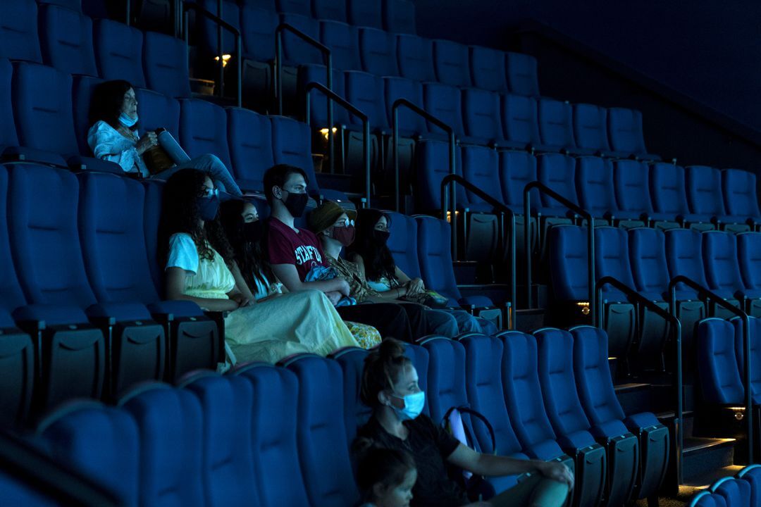People watch a movie in the newly opened theater at the Aquarium of the Pacific in Long Beach, California, June 15, 2021.