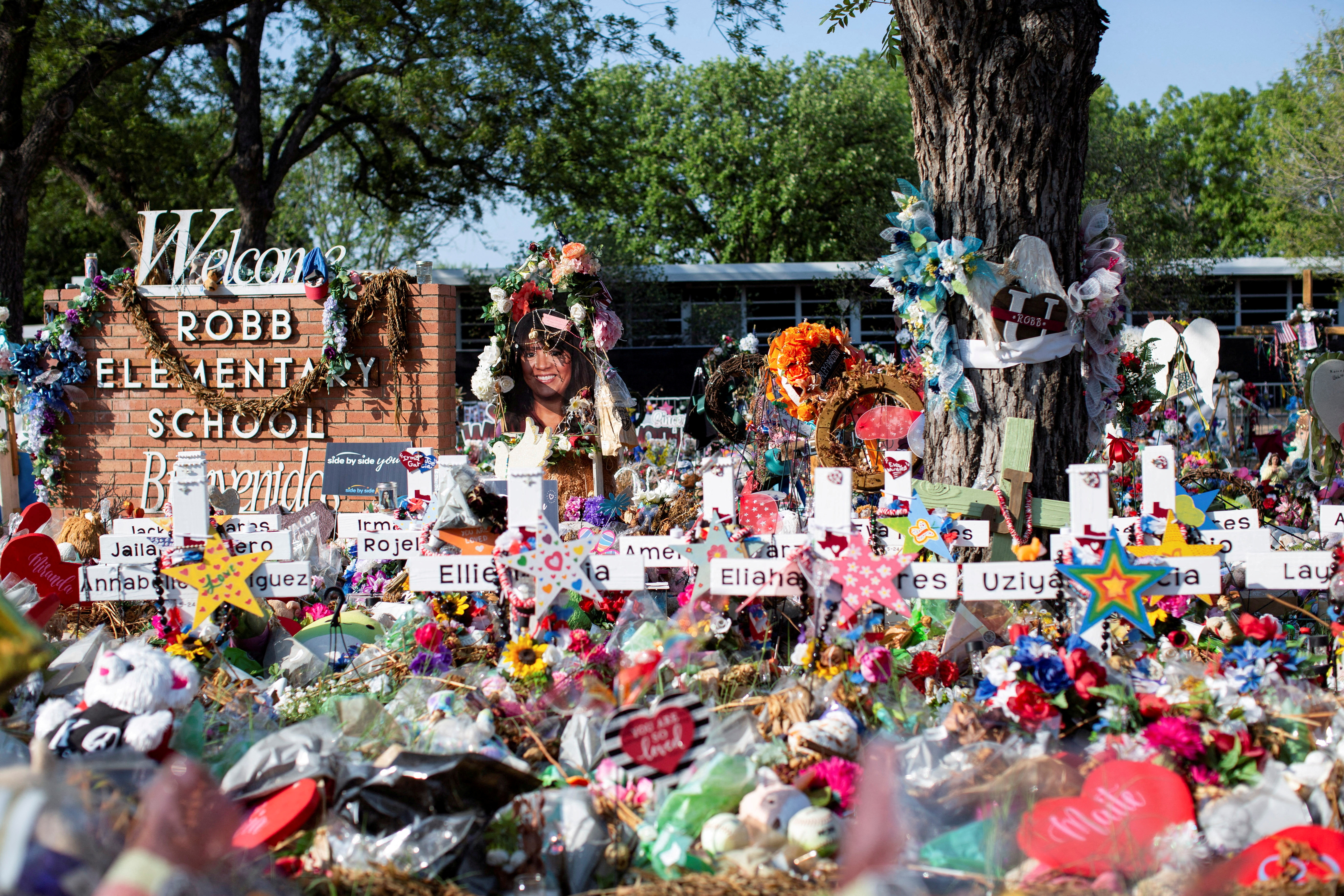 Privacy barriers and bike racks maintain a perimeter at a memorial outside Robb Elementary School, after a video was released showing the May shooting inside the school in Uvalde, Texas, July 13, 2022.