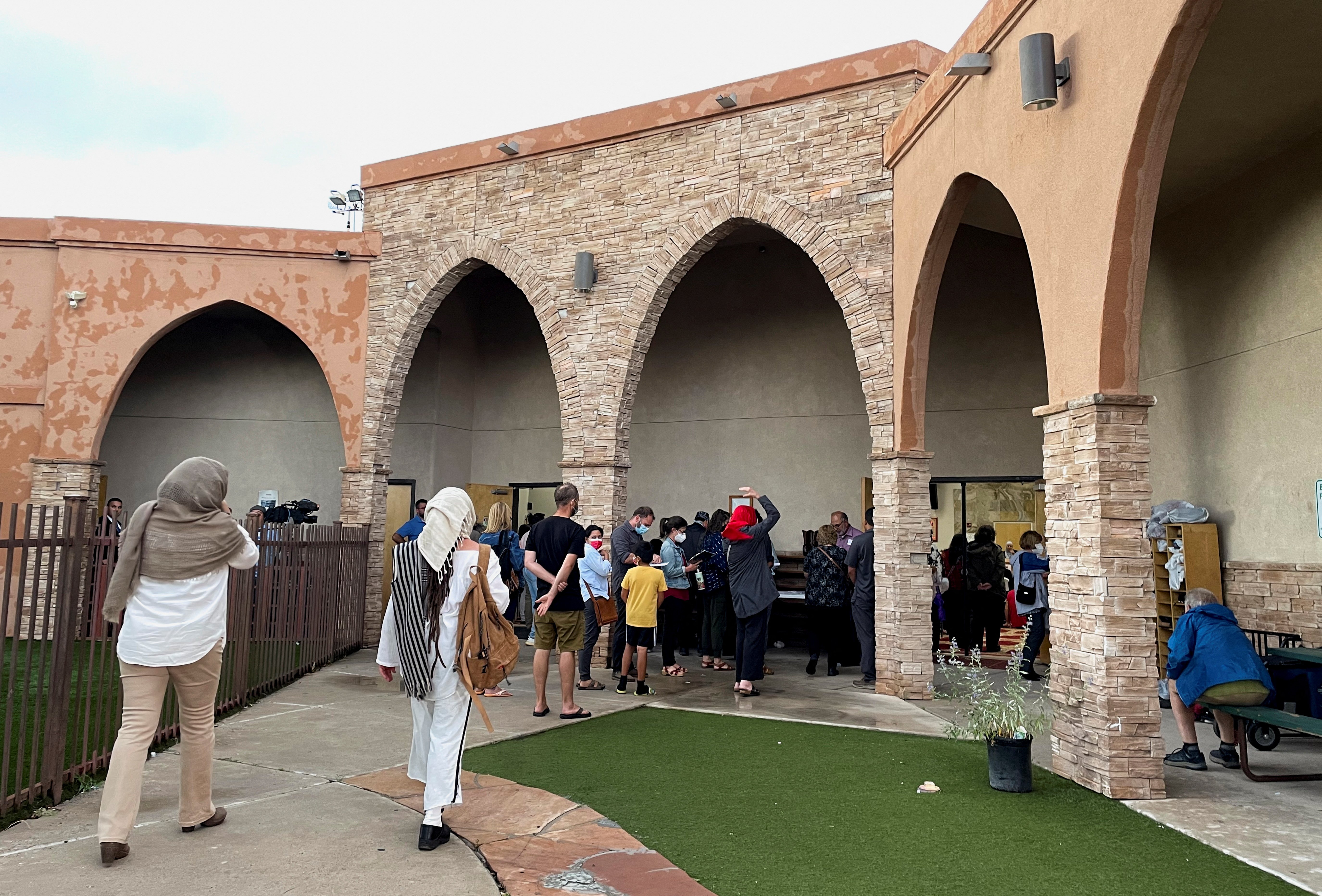 Participants in an interfaith memorial ceremony enter the New Mexico Islamic Center mosque to commemorate four murdered Muslim men, hours after police said they had arrested a prime suspect in the killings, in Albuquerque, New Mexico, Aug. 9, 2022.