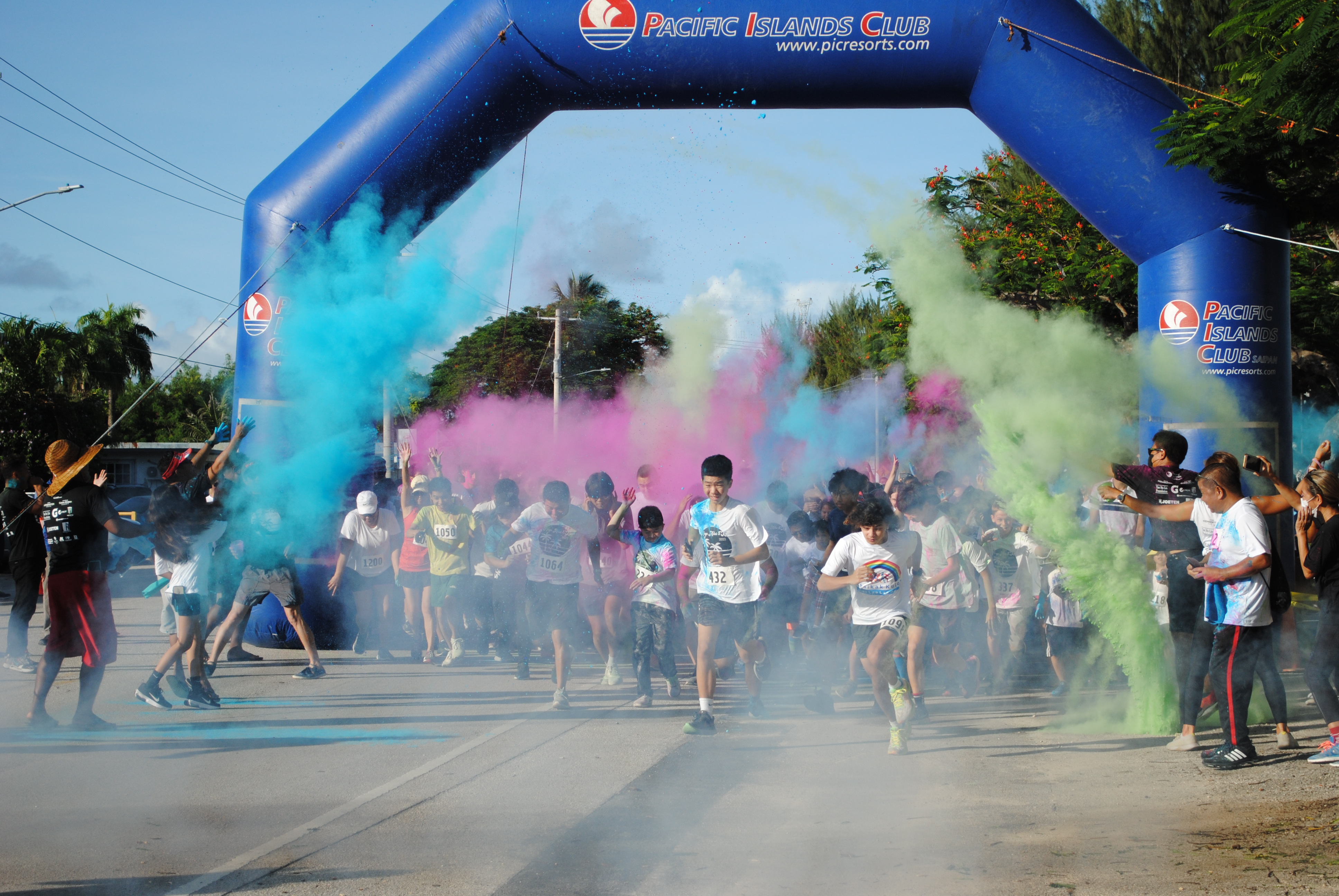 Participants run through a bombardment of colors at the start of  the PIC Hafa Adai 5K Color Run on Saturday.
