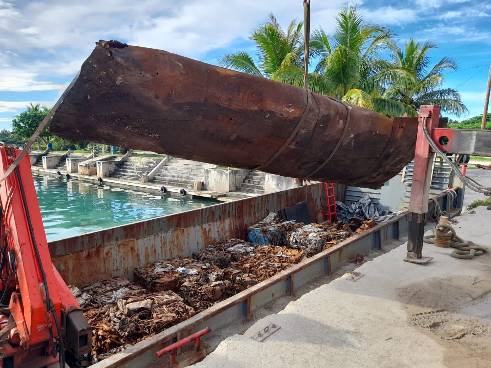 In one of its daily updates with CNMI partners, APEC reports on Aug. 22 that pieces of an old metal tank and pallets of baled metal loaded at the dock on Tinian for shipping and recycling. The metal debris will be sent to Saipan for recycling by subcontractor Triple Star Recycling.