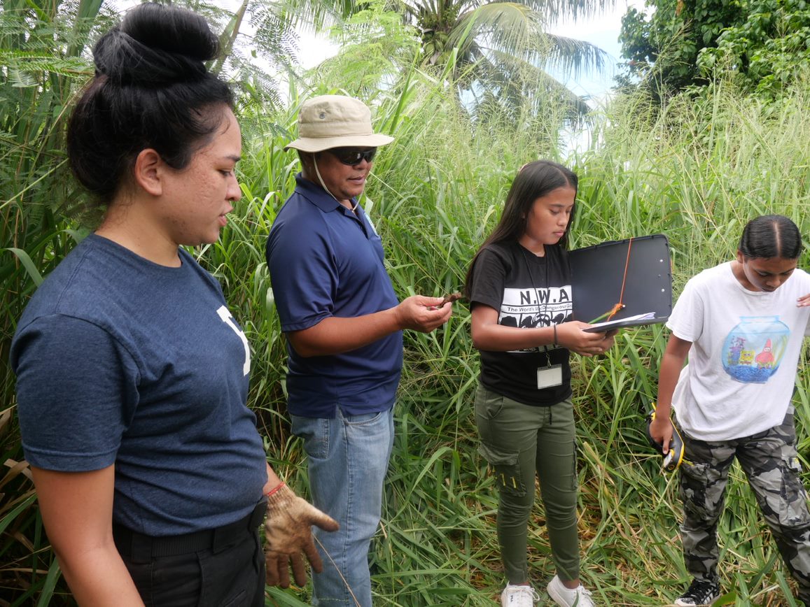IRP Anthropologist Keona DLG Torres, NMHC DR Loan Specialist Melvin Sablan with CNMI Youth Affairs Governor’s Summer Youth Employment Program interns Jovinia Moses and Heather Kristopher complete an IRP archaeological survey in Kagman on Aug. 12, 2022.