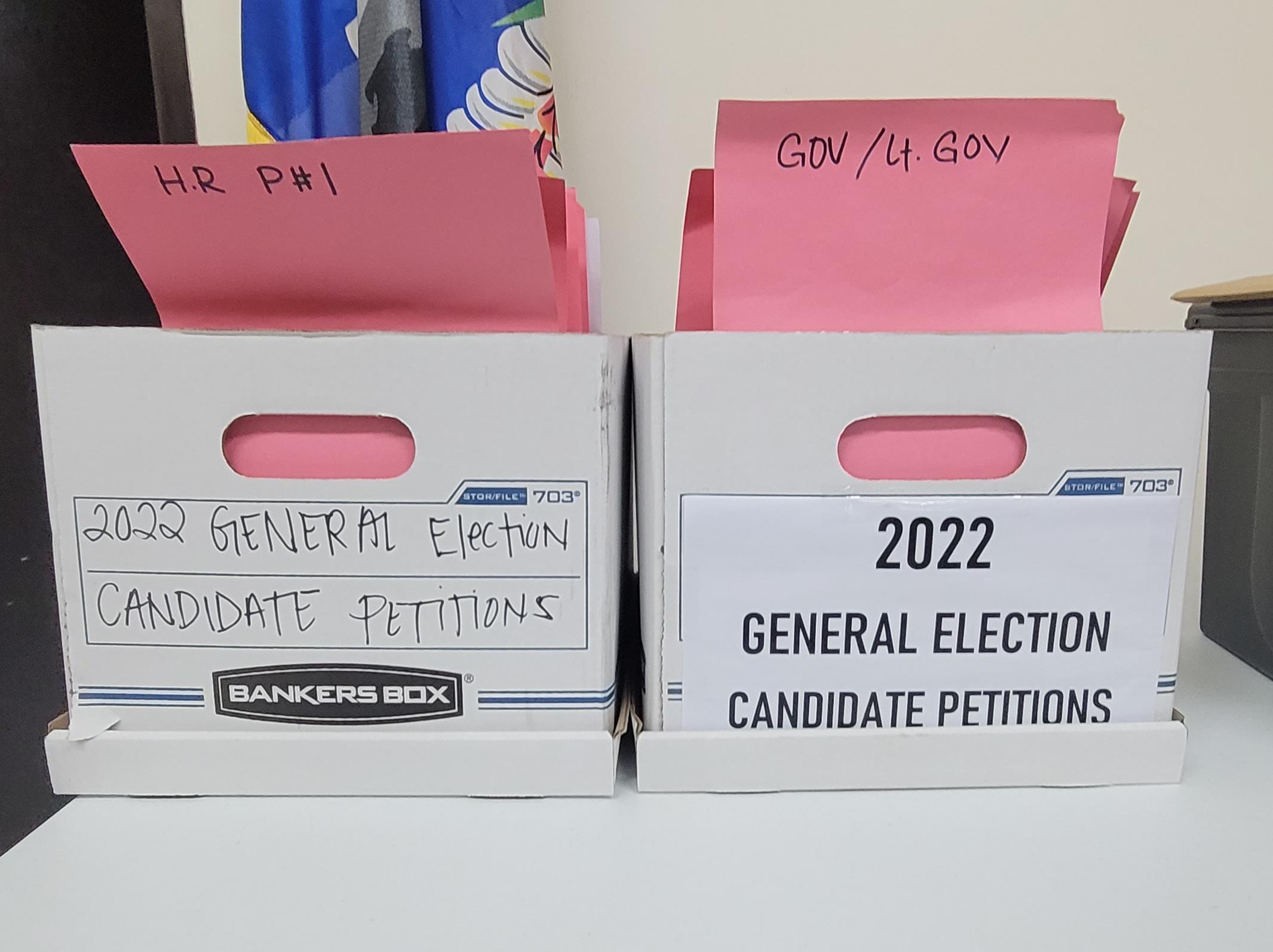Boxes containing petitions of candidates for the Nov. 8 general election sit atop a table during the election commissioners' meeting last week.