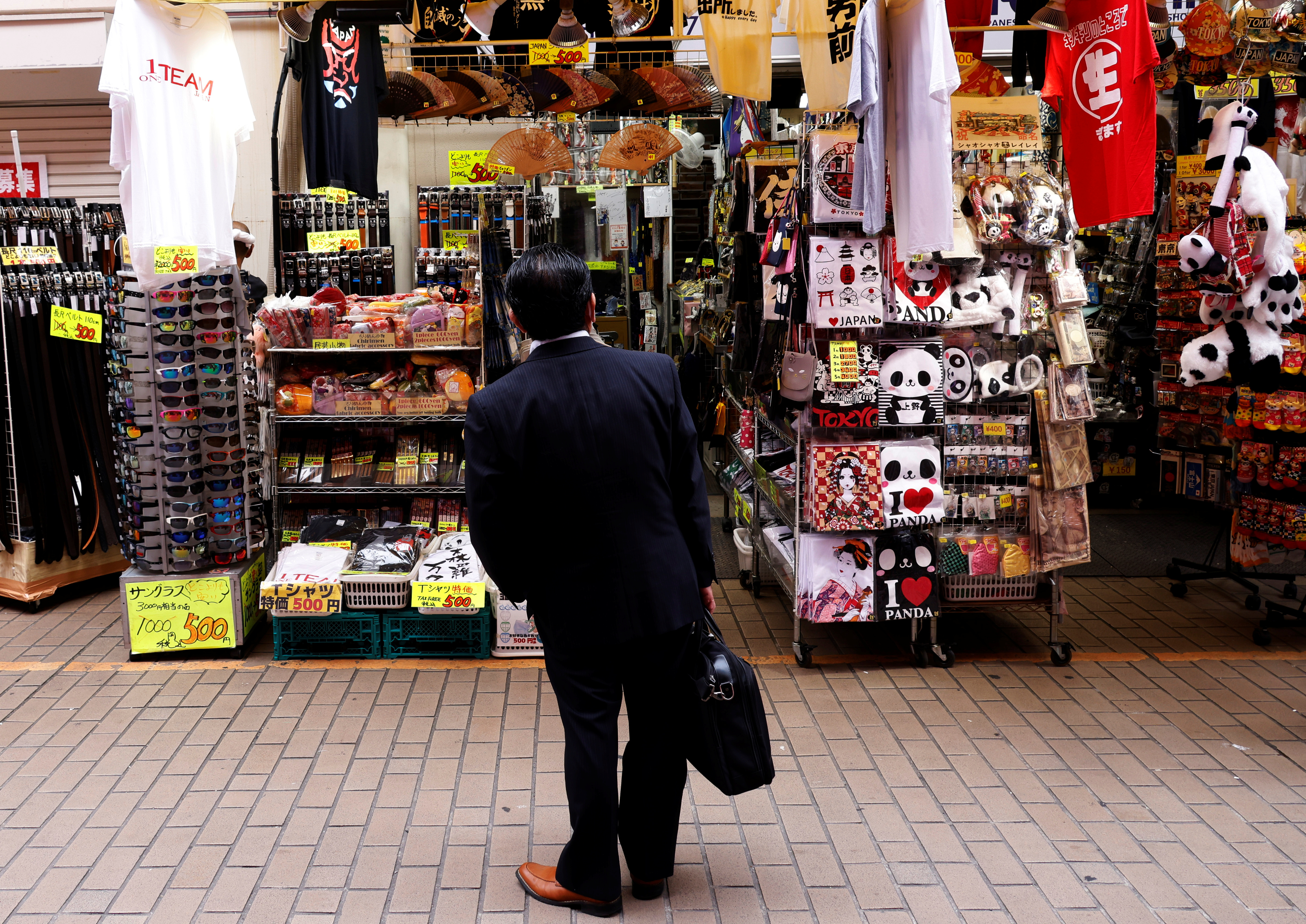 A man looks at a shop at the Ameyoko shopping district in Tokyo, Japan, May 20, 2022.