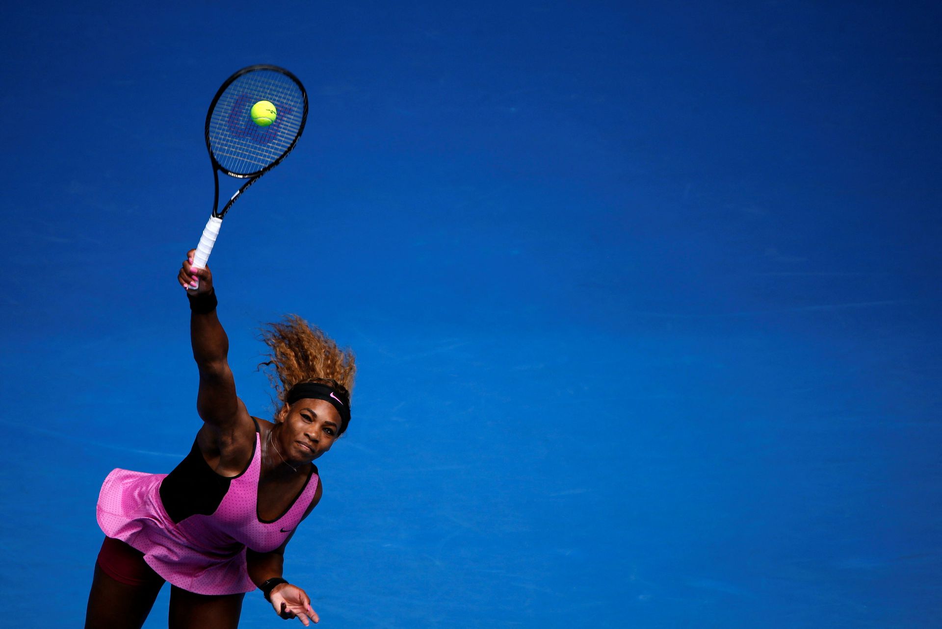 Serena Williams of the U.S. serves to Ana Ivanovic of Serbia during their women's singles match at the Australian Open 2014 tennis tournament in Melbourne, Jan. 19, 2014.