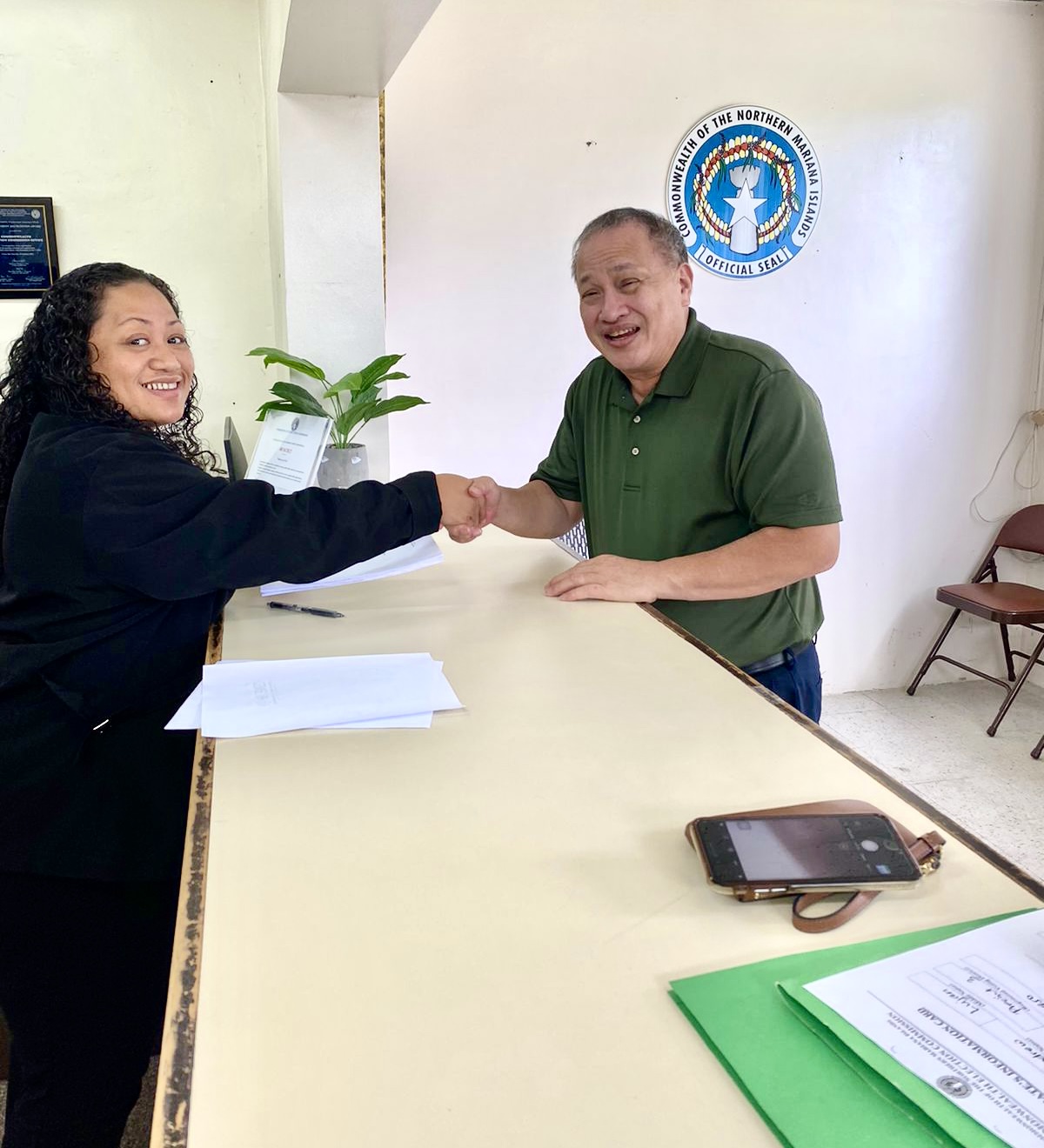 Board of Education member Andrew L. Orsini of Saipan shakes hands with Commonwealth Election Commission Executive Director Kayla Igitol after submitting his candidacy documents on Monday. Orsini is seeking a second term on the BOE.