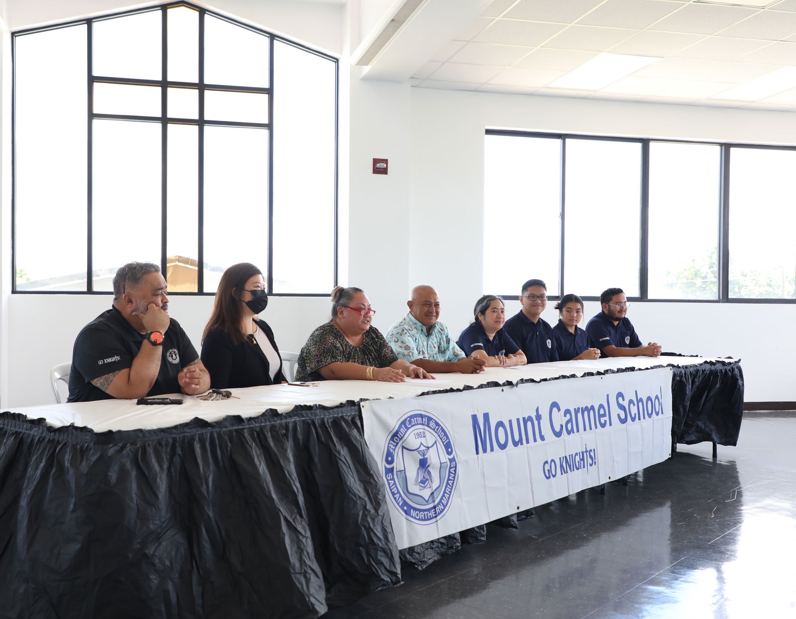 Members of Mount Carmel School’s board of directors and leadership team participate in a press conference which announced Frances T. Taimanao as the new school president.