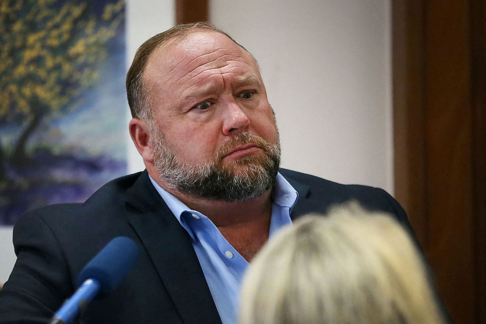 Alex Jones attempts to answer questions about his emails asked by Mark Bankston, lawyer for Neil Heslin and Scarlett Lewis, during trial at the Travis County Courthouse, Austin, Texas, Aug. 3, 2022.