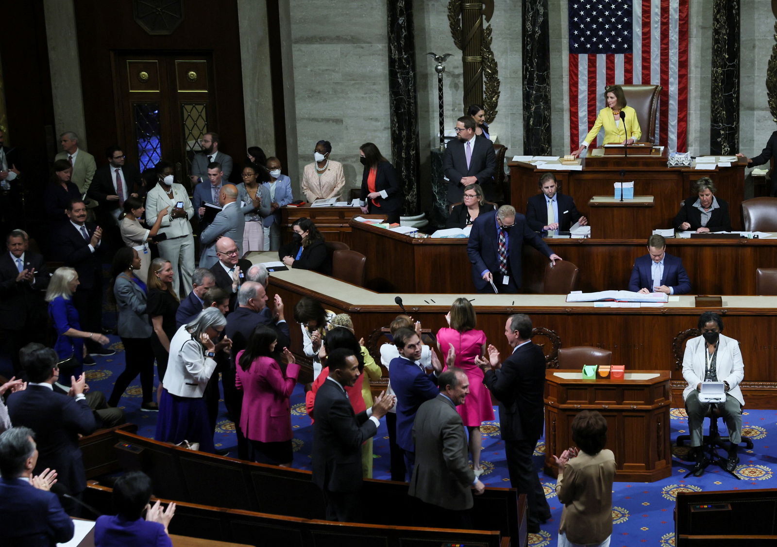 Democratic members of the U.S. House of Representatives applaud and celebrate as Speaker of the House Nancy Pelosi, D-Ca., lays down her gavel after the House passed H.R. 6376, the "Inflation Reduction Act of 2022," which has already passed the U.S. Senate, in the House chamber of the U.S. Capitol in Washington, D.C., Aug. 12, 2022.