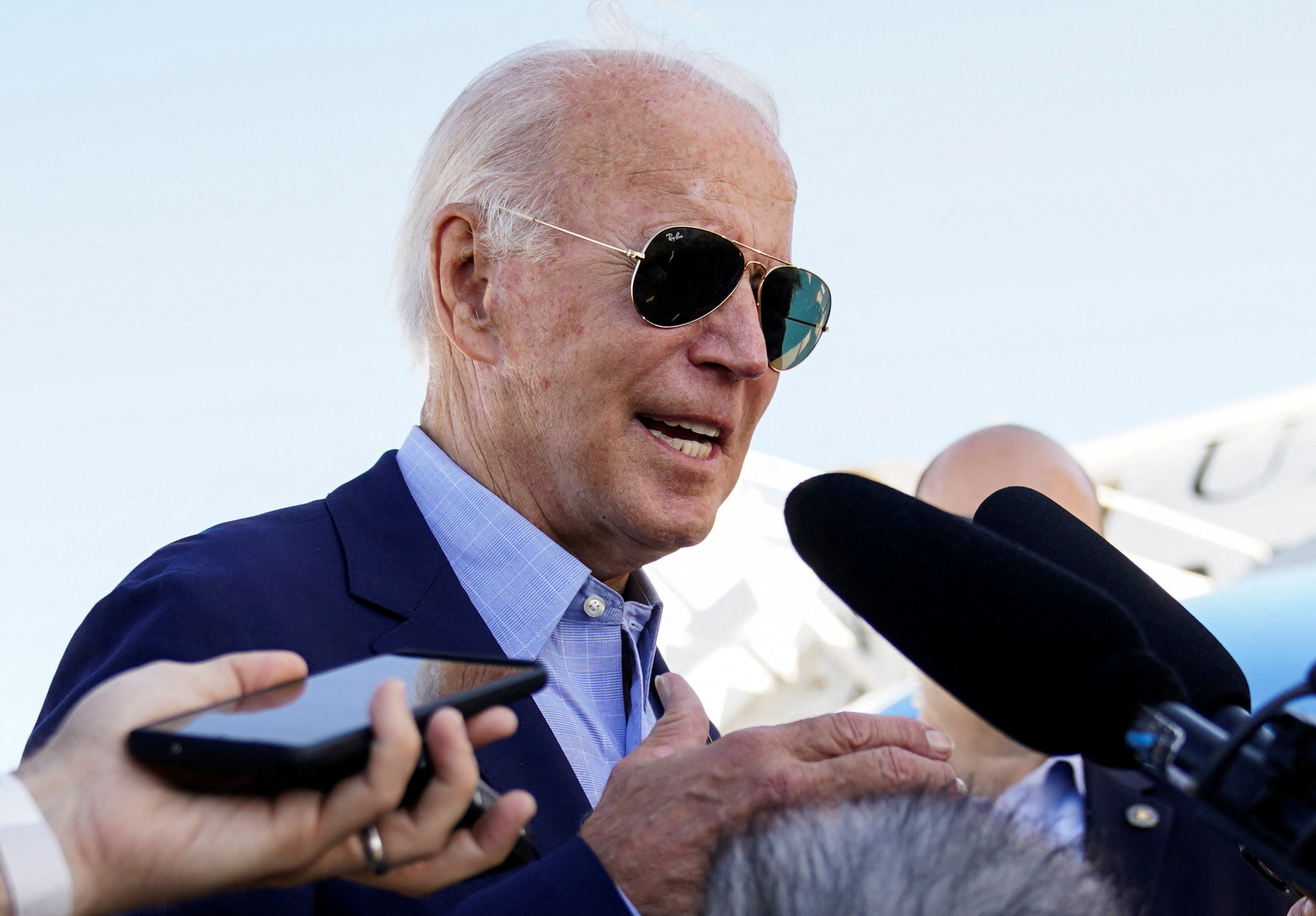 President Joe Biden talks to reporters while boarding Air Force One on travel to Eastern Kentucky to visit families affected by devastation from recent flooding, as he departs from Delaware Air National Guard Base in New Castle, Delaware, Aug. 8, 2022.