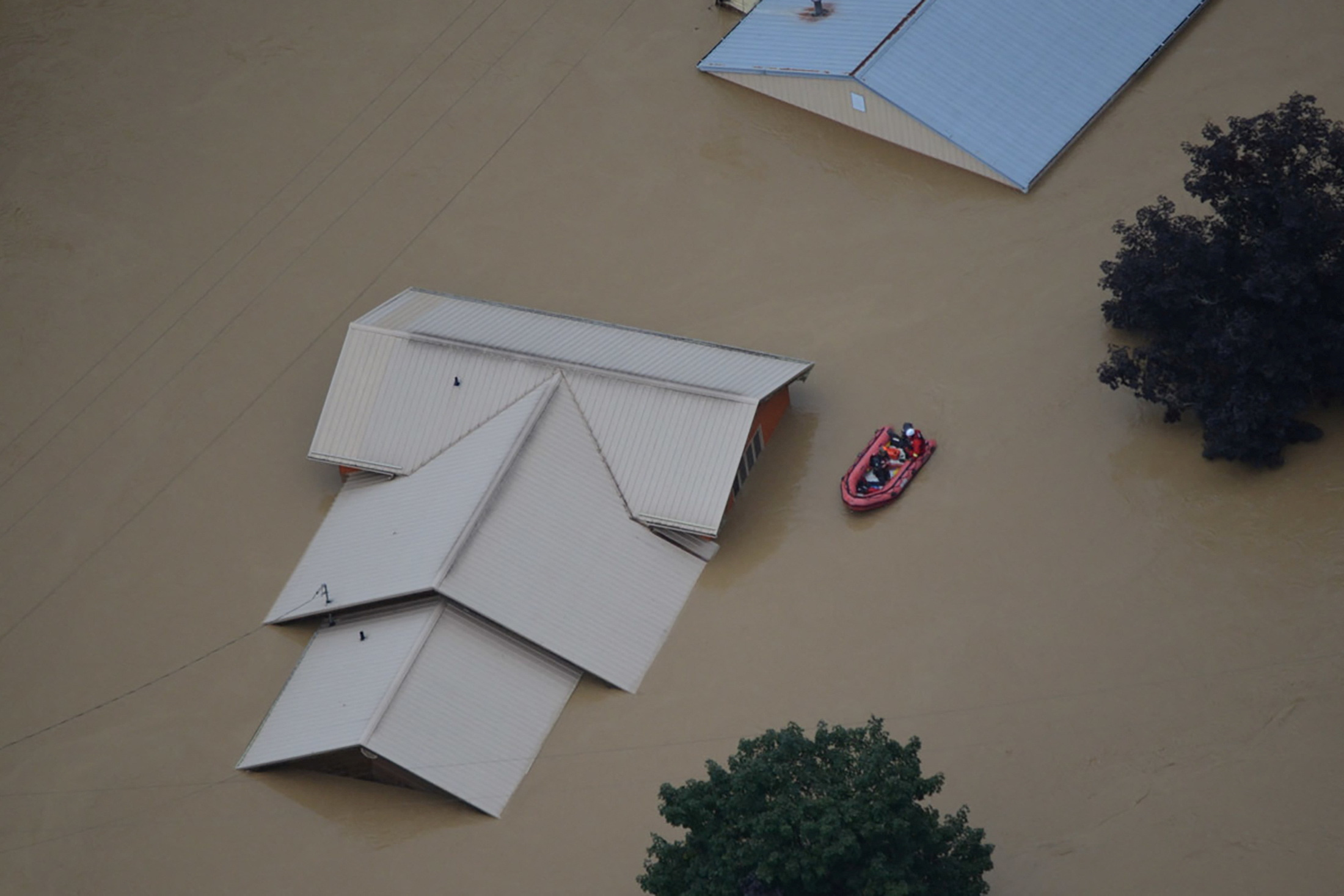 A flooded area is flown over by a Kentucky National Guard helicopter deployed in response to a declared state of emergency in eastern Kentucky, July 27, 2022.