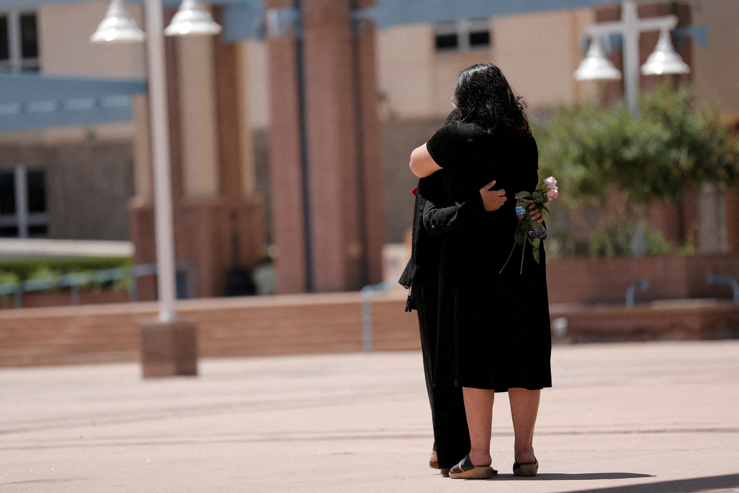 Two people embrace during a unity event against anti-Shia hate following the murders of four Muslim men in Albuquerque, New Mexico, Aug. 12, 2022.