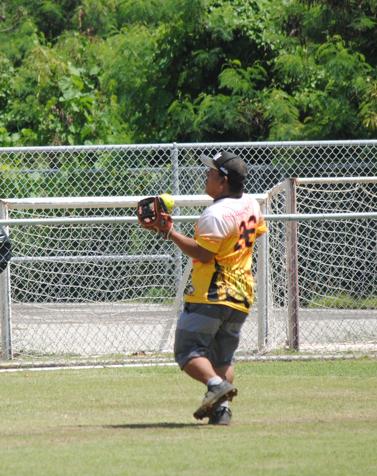 Hagu Lamun's Joe Celis catches the pop fly during a  2022 Budweiser Belau Amateur Softball League game at the Dandan baseball field