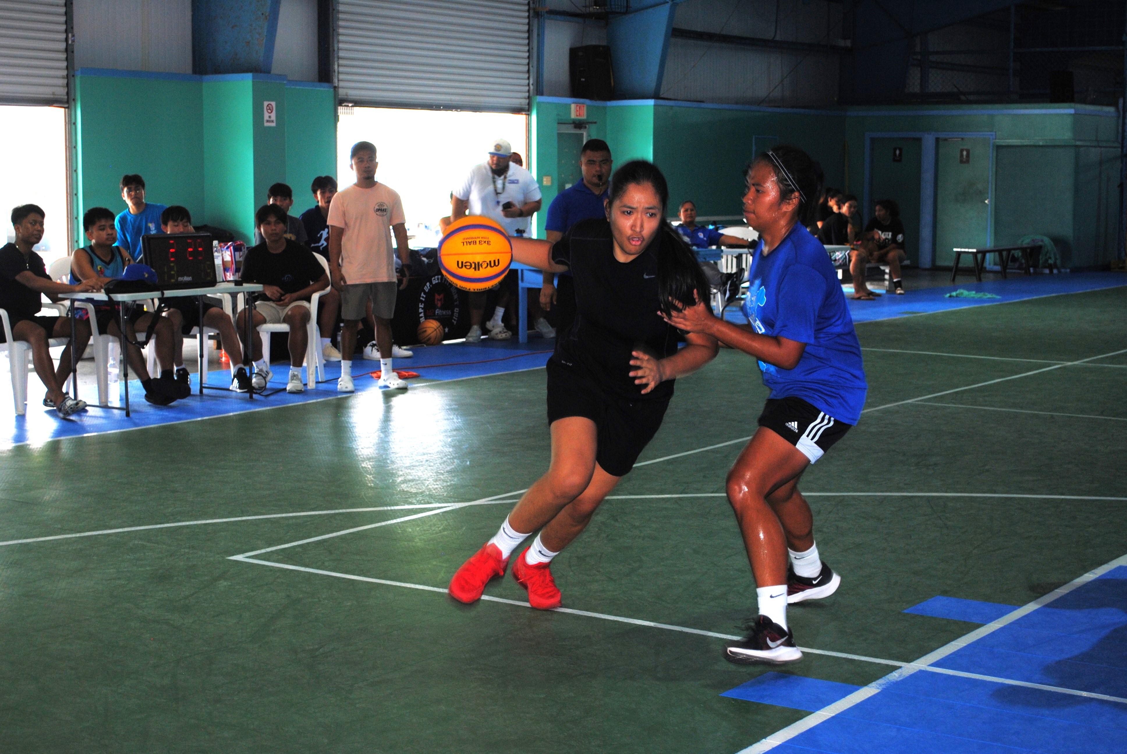 Hotshot's Madeleine Alegre protects the ball as she attempts to drive past 4Funsies' Dianne Pablo during the  championship game of the Northern Mariana Islands Basketball Federation’s Three vs Three Hoop Fest Tournament on Saturday at the TSL Sports Complex.