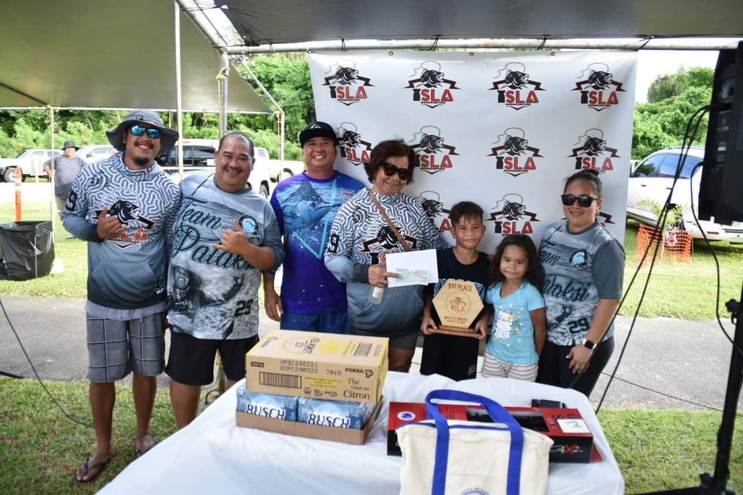 Members of Team RJ pose with their first place trophy alongside ISLA members at the conclusion of the 4th Annual ISLA Mafuti Derby on Saturday at Smiling Cove Marina.