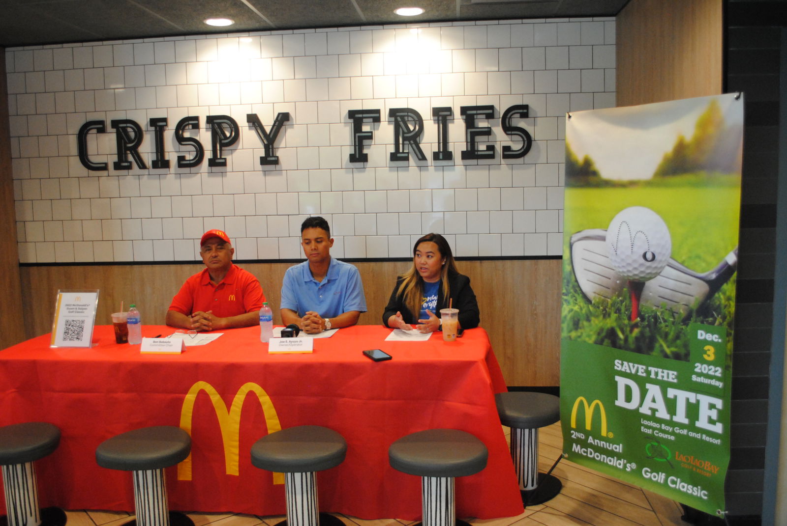 McDonald’s executive assistant to the president Natalie Mable Ayuyu-Glenn, right, gestures as she speaks during a media conference Friday while McDonald's owner/operator Joe Ayuyu Jr., center, and organizing committee chairman Vicente Babauta listen.