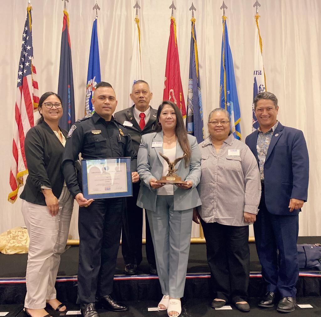 U.S. Customs and Border Protection-CNMI Port Director Jeff Hofschneider Jr., second left, holds the Above & Beyond Award, as he poses for a photo with Employer Support of the Guard and Reserve Guam-CNMI Ombudsman Joann Aquino, center, who is holding her ESGR Spirit of Volunteerism Award, ESGR Employer Outreach Coordinator Rose Igitol, second right, ESGR State Chairman Ret. Lt. Col. Rey Llaneta, back row, CNMI Office of the Governor Chief of Staff Wil Castro, right, and ESGR volunteer Joshlyn Blas, left, during the ESGR 14th Annual Employer Awards Ceremony at the Hyatt Regency Guam on Aug. 18.
