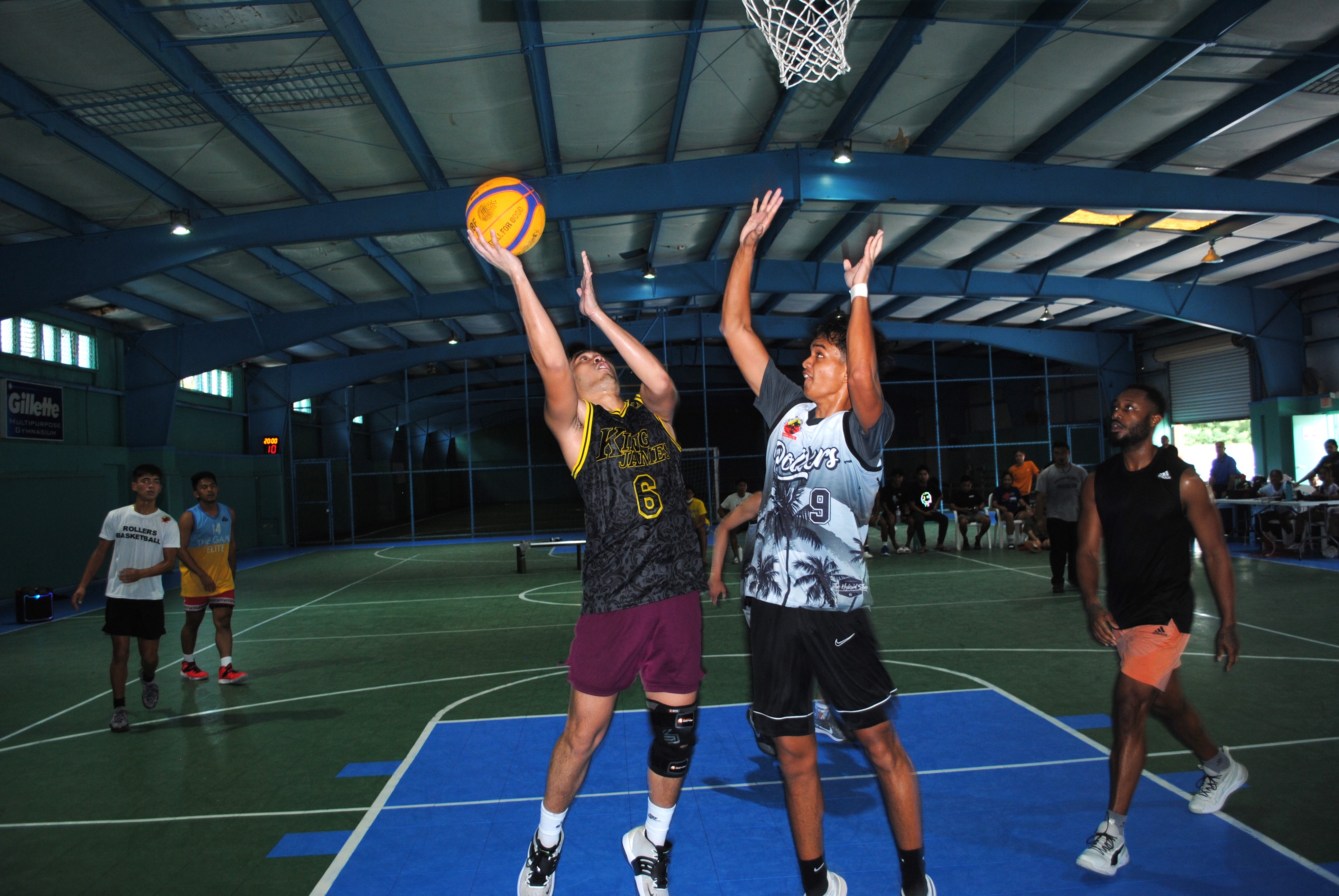 DJ Ong takes the contested put back from underneath the rim.