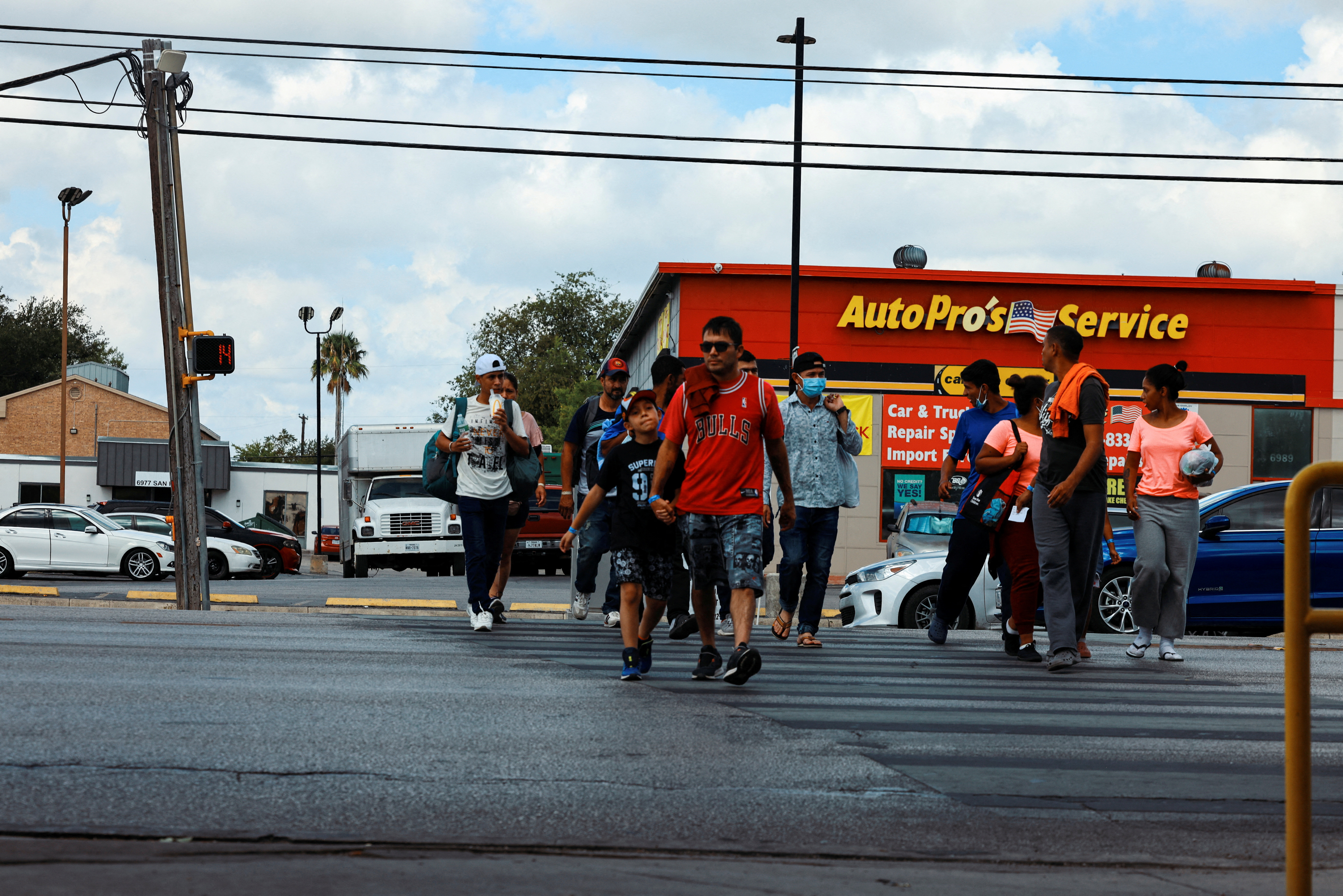 Migrants walk outside the City of San Antonio Migrant Resource Center, where two planeloads of mostly Venezuelan migrants sent via Florida to Martha’s Vineyard in Massachusetts had originated, in San Antonio, Texas,  Sept. 16, 2022.