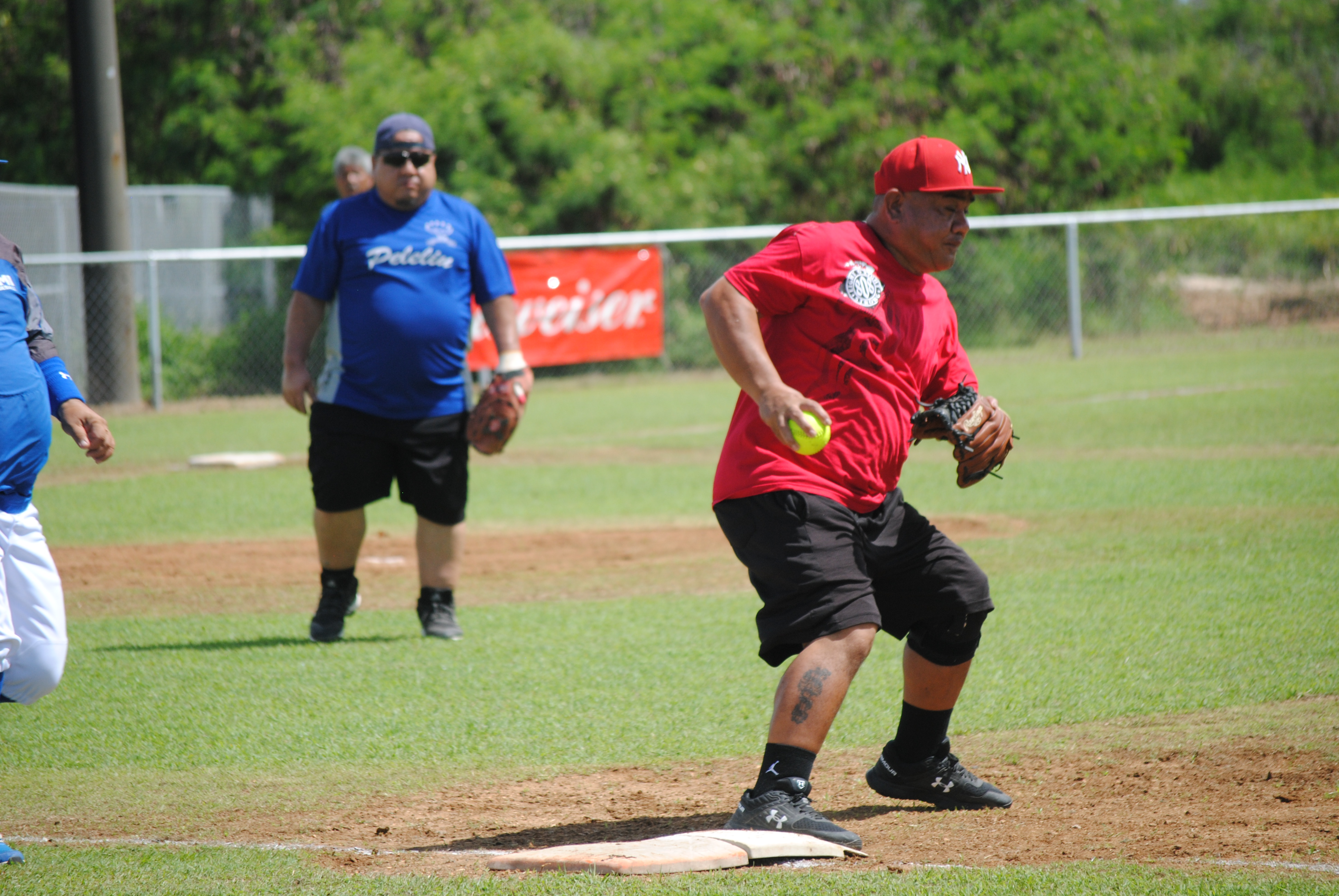 Peleliu's first baseman Jun Lizama steps on the plate for the out during a 2022 Budweiser Belau Amateur Softball League game at the Dandan baseball field.