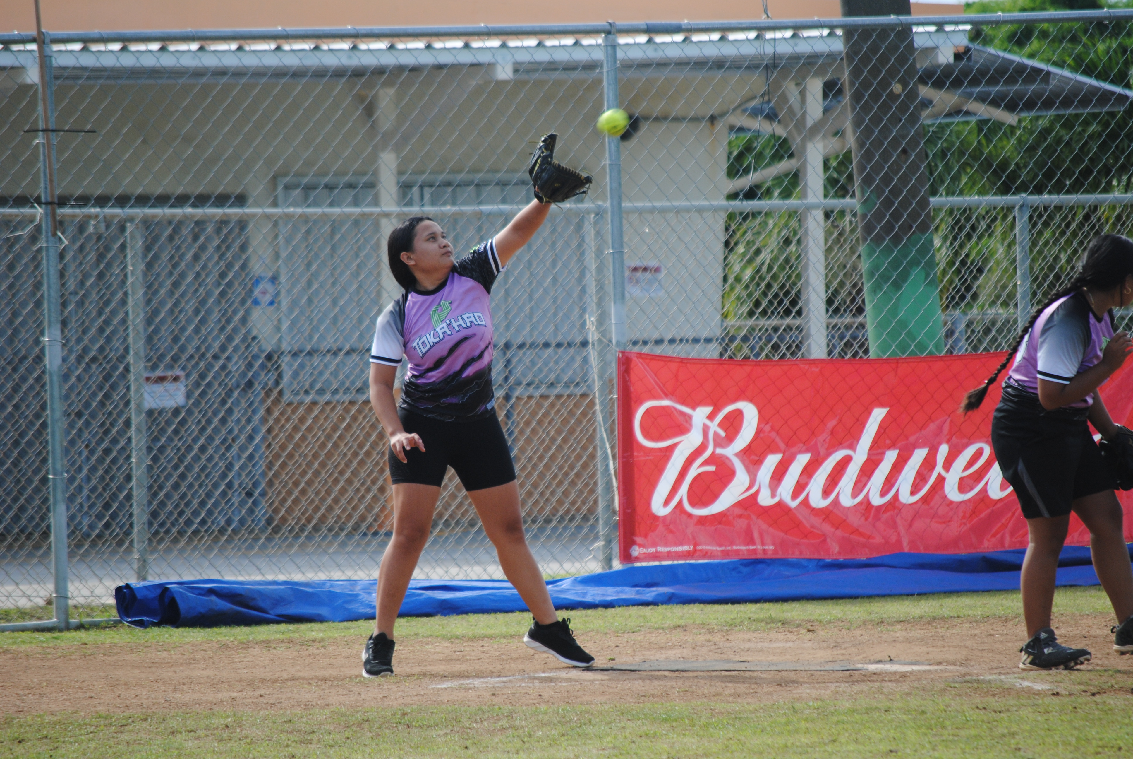 Tokahao Ladies catcher Jennylyn Olupumar reaches out in an attempt to tag an incoming runner during a 2022 Budweiser Belau Softball Amateur League game Sunday at the Dandan baseball field.