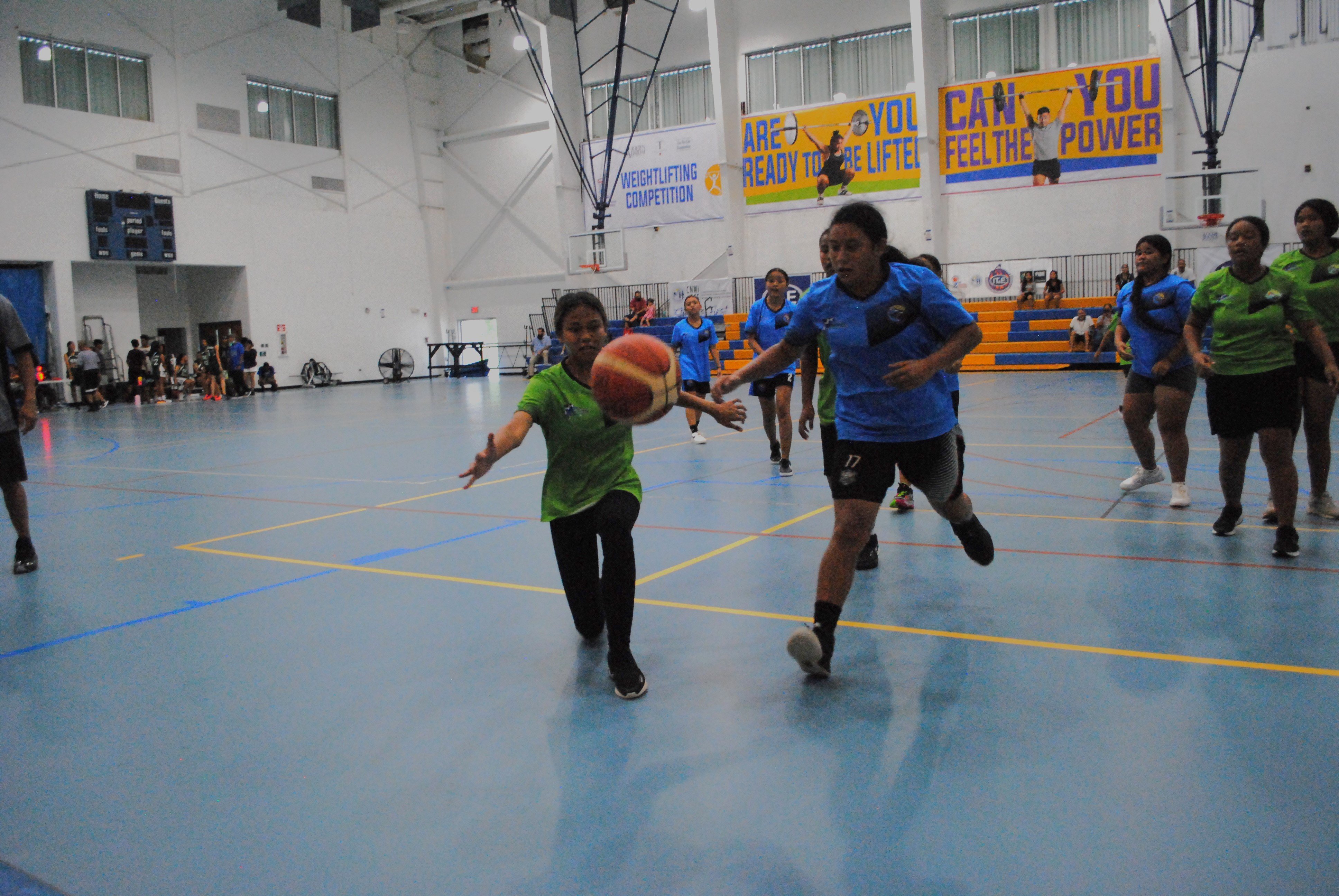 FMS' Rosie Saralu and a defender go after a loose ball during an IT&E Interscholastic Girls Middle School Basketball League game at the MHS gym.