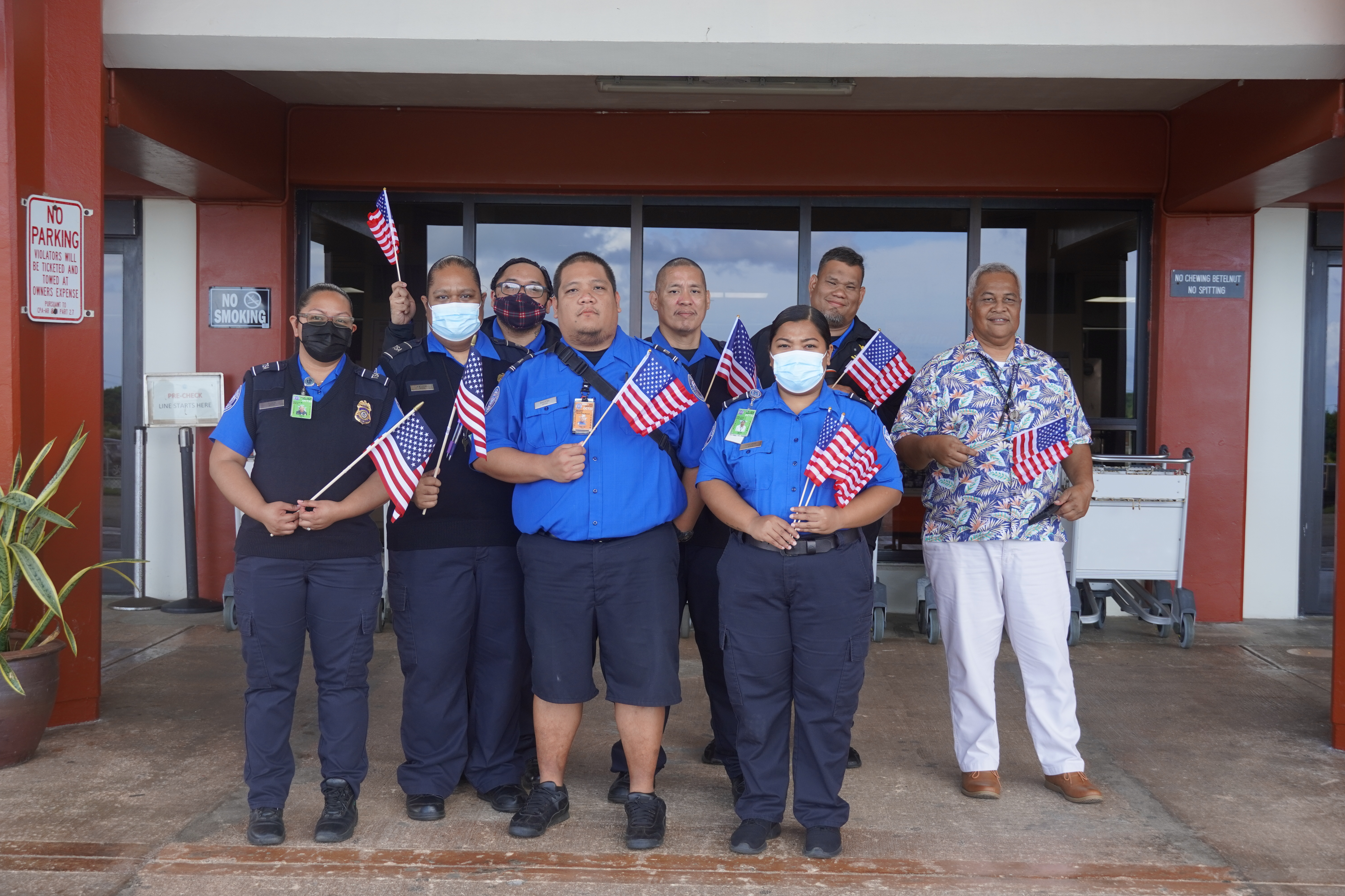 Transportation Security Administration agents, including Henry Litulumar, far right, who has been with the agency since its roll-out, pose for a photo on Saturday morning.