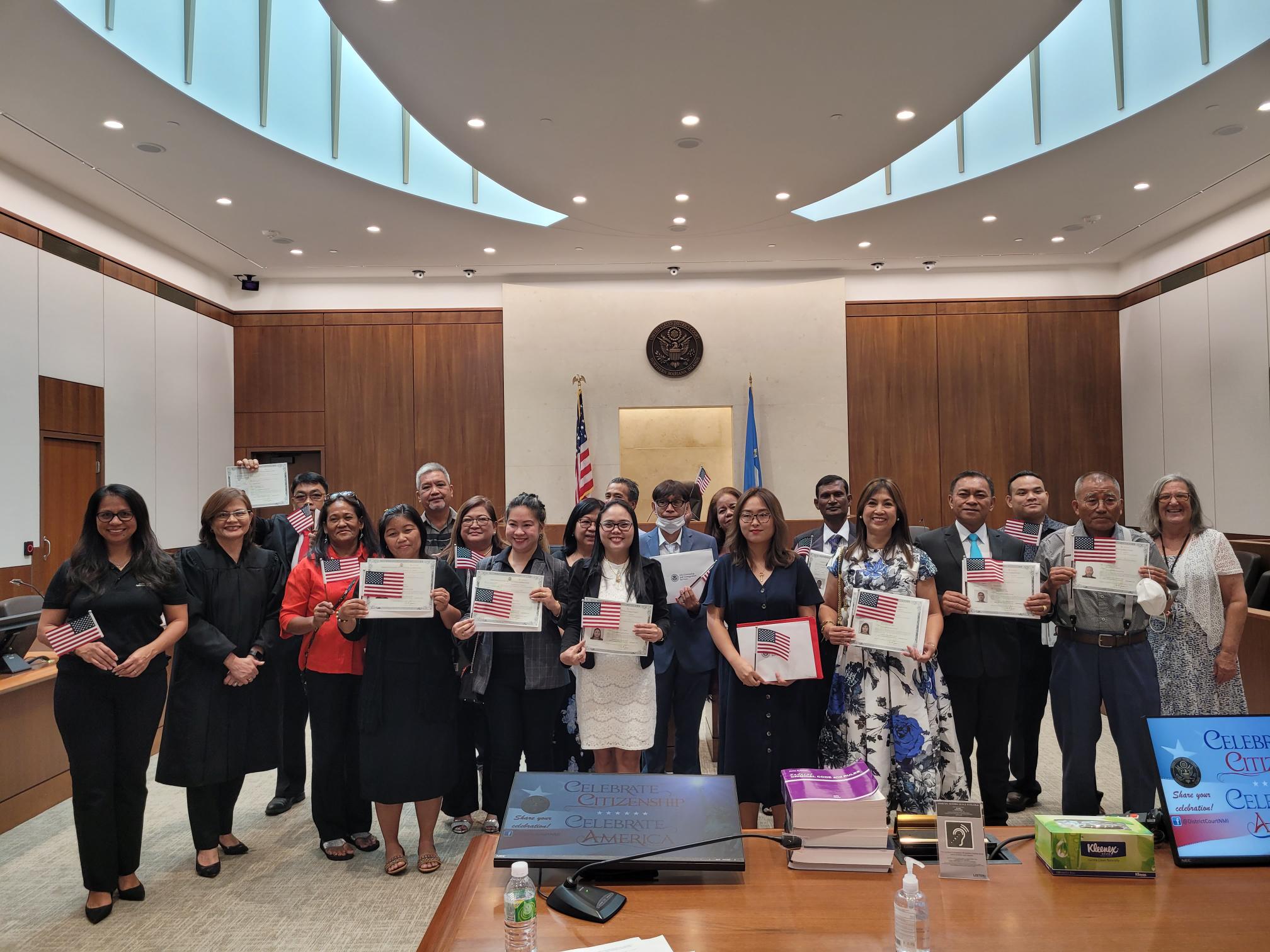 Following a naturalization ceremony in federal court on Monday afternoon, the new U.S. citizens pose for a photo with Chief Judge Ramona V. Manglona, the guest speaker, Northern Marianas Coalition Against Domestic and Sexual Violence Executive Director Maisie Tenorio, and Patricia Phelan, U.S. Citizenship and Immigration Services officer.
