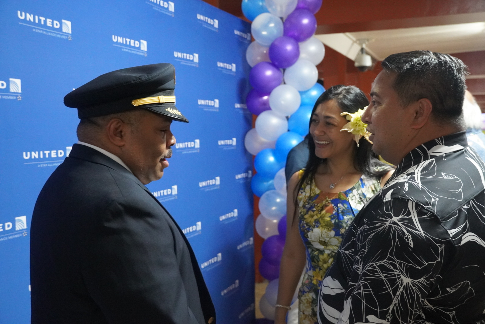 Gov. Ralph DLG Torres and First Lady Diann T. Torres converse with United Airlines pilot Errol Lee.