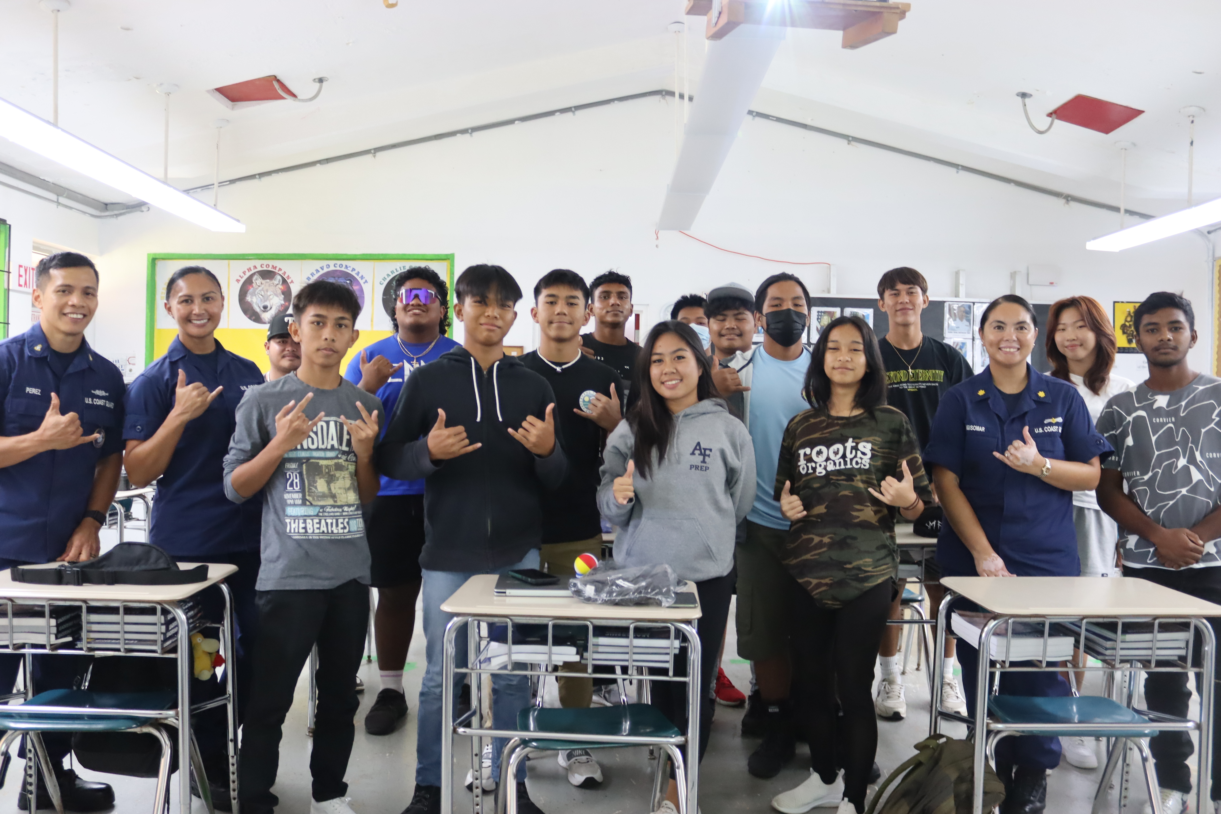 Members of the Coast Guard pose with cadets of the Tinian JROTC Stallion Battalion.