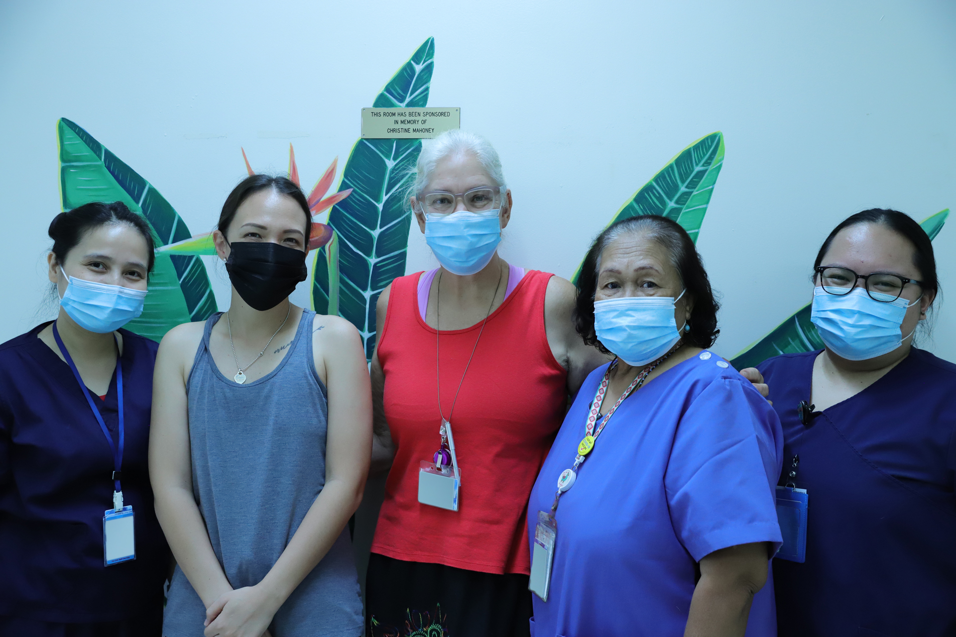 From left, Nica Legaspi, Meena Benavente, Rhonda Dicostanzo, Flavy Saimon and Kristine Batac pose with the new mural at the hospital.