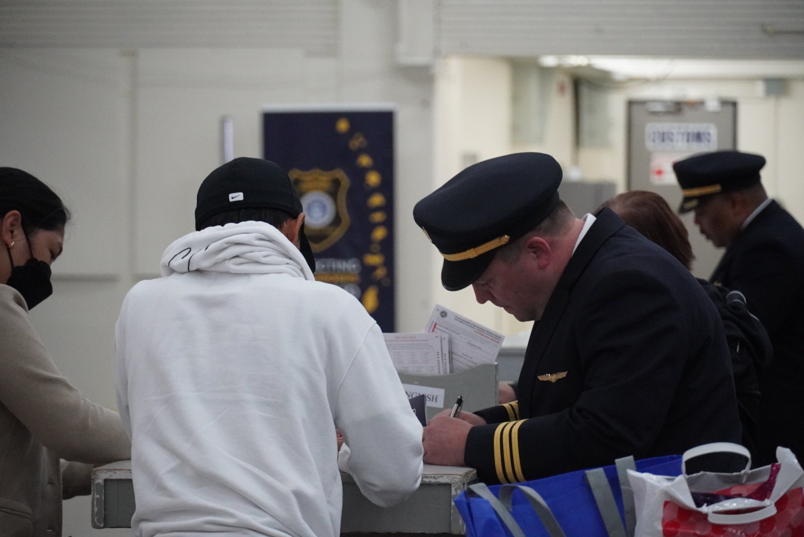 United Airlines pilots and passengers fill out customs forms at the Francisco C. Ada/Saipan International Airport.