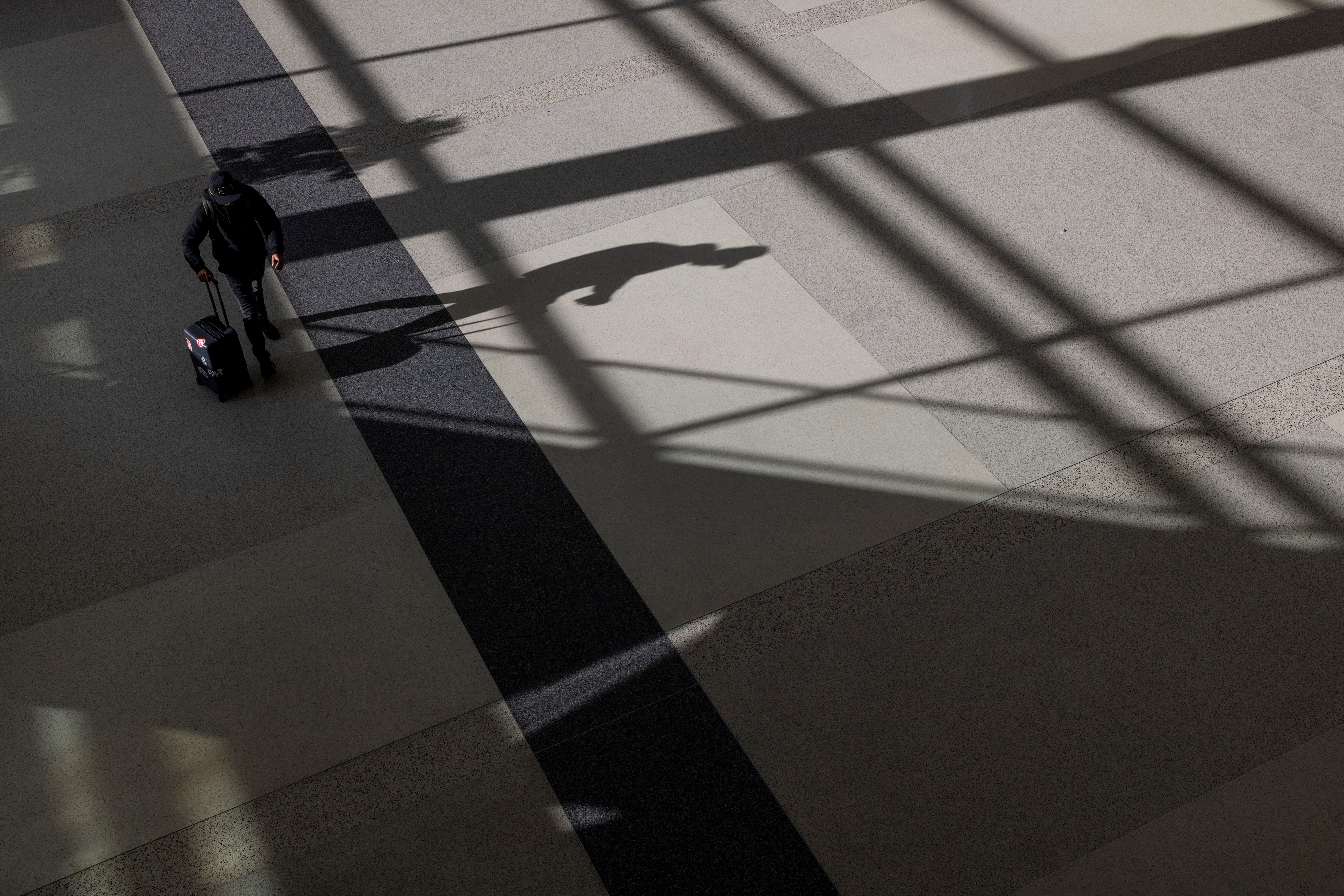 A passenger walks along terminal 2 at the San Francisco International Airport in San Francisco, California on Sept. 3, 2022.
